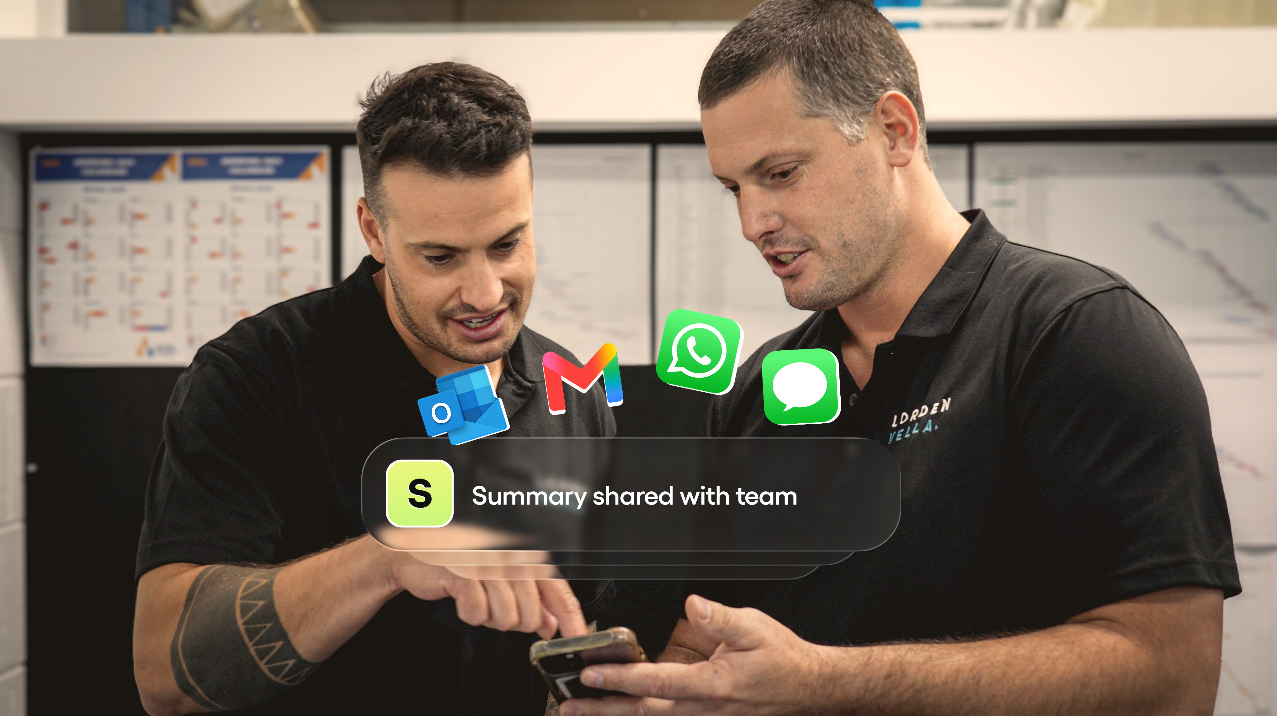 Two workers sharing a supasite write-up on a phone