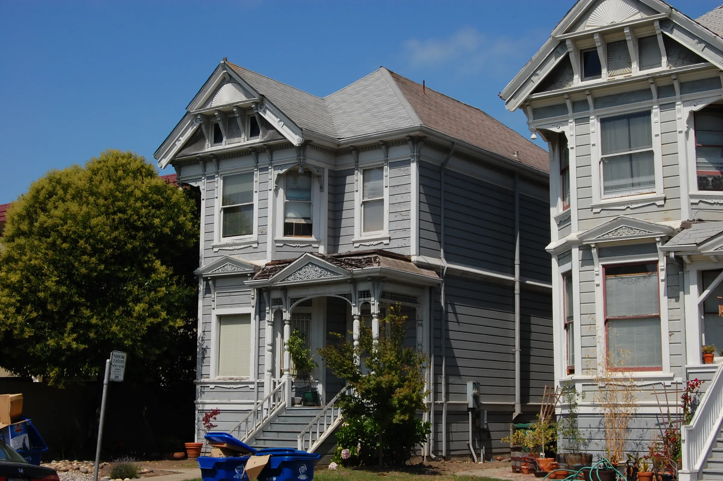 Two restored gray Victorian houses on Everett Street in Alameda