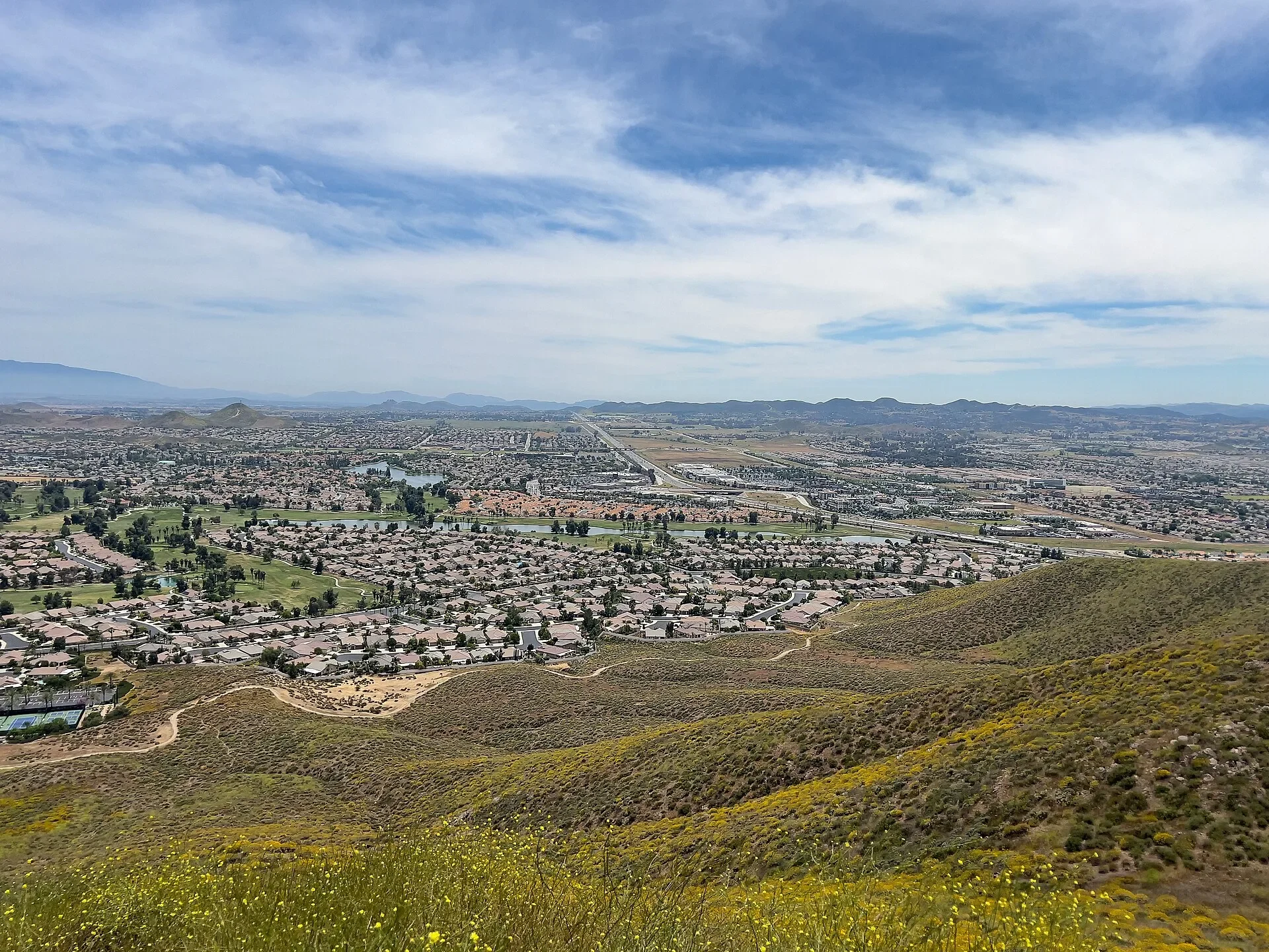View over Menifee neighborhoods and the valley from the green Menifee Hills in spring