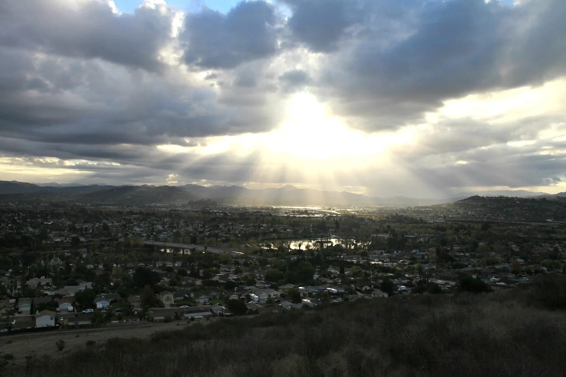 Sunlight breaking through clouds over Santee and Santee Lakes, near the Weston neighborhood