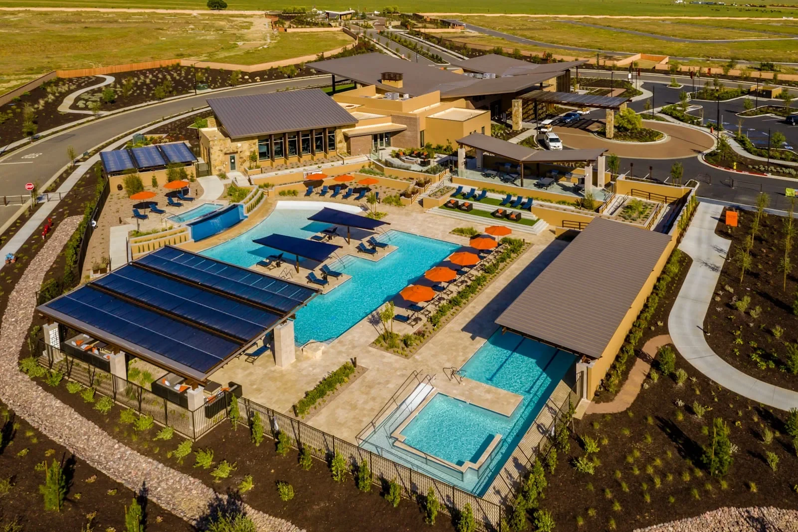 Aerial view of the Altis residents' clubhouse with a resort pool, lap pool, and shaded lounge areas in Beaumont, California