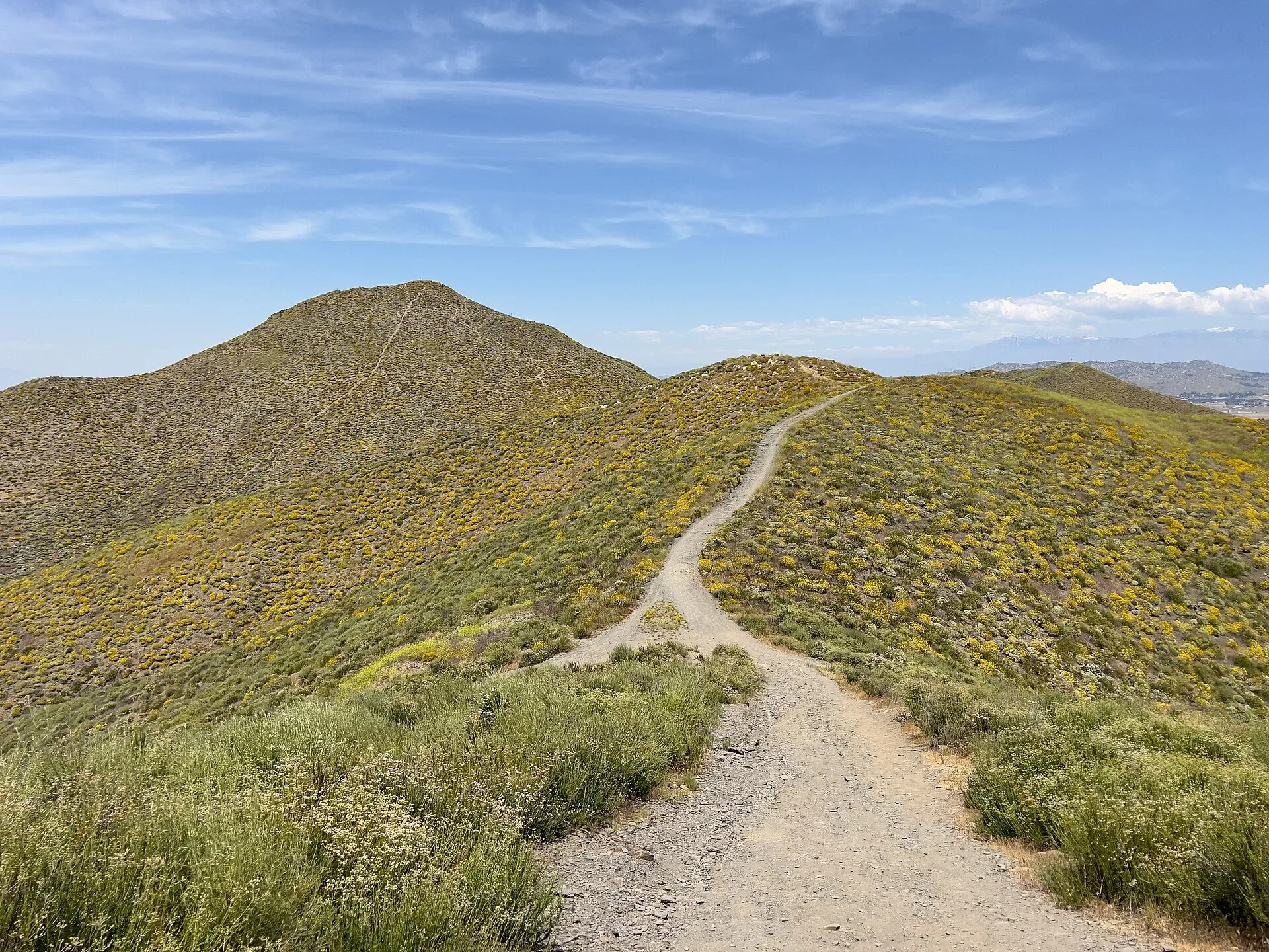 Hiking trail along a green ridge in the Menifee Hills in spring