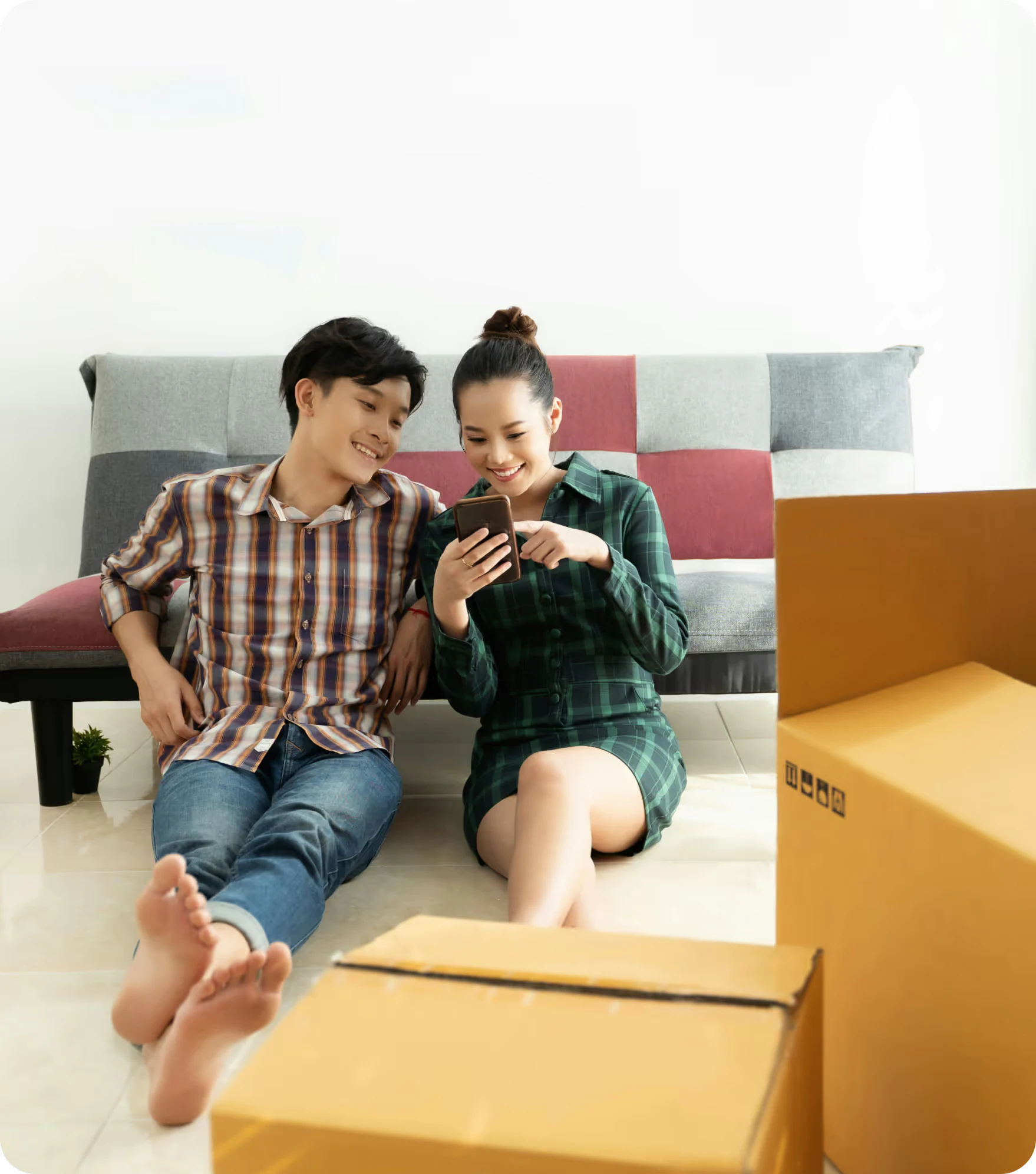 Happy couple in room with moving boxes.