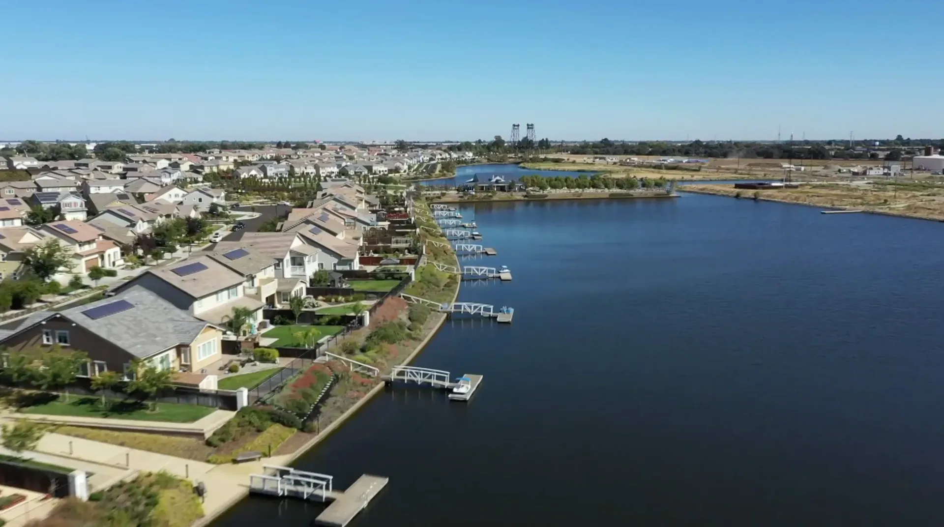 Aerial view of lakefront homes with private docks at River Islands in Lathrop, California