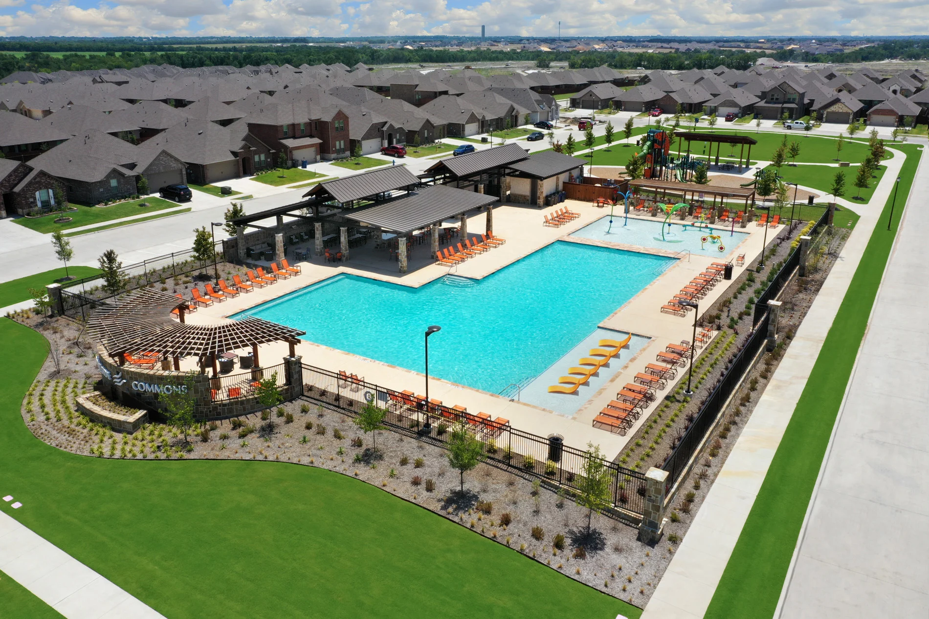 Aerial view of the Trailside Commons pool and amenity center surrounded by new homes in Elevon, Lavon, Texas