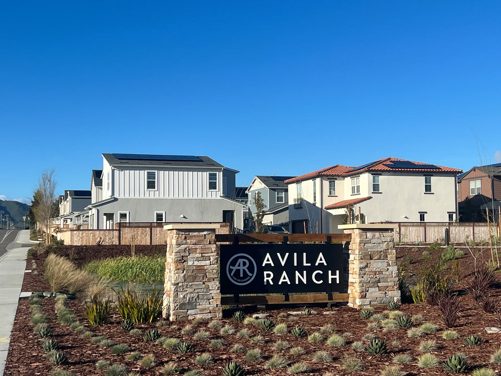 Avila Ranch entry sign in front of new two-story homes in San Luis Obispo, California