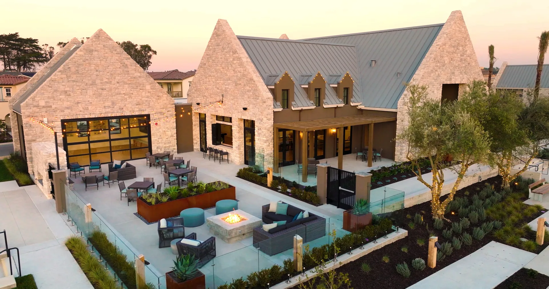 Patio with fire pit and seating outside The Cove Clubhouse at Sea Haven in Marina, California