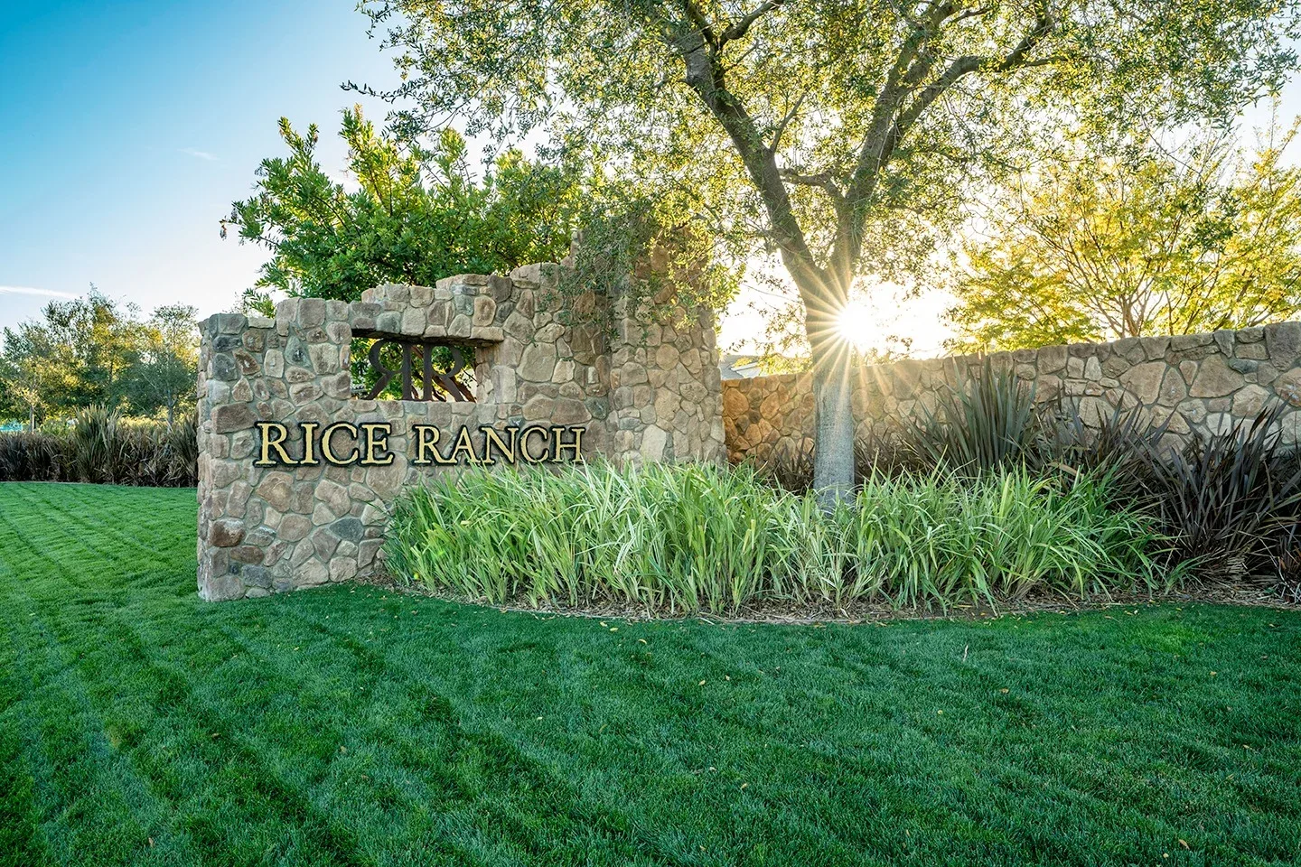 Stone Rice Ranch entry monument with landscaping and oak trees in Orcutt, California