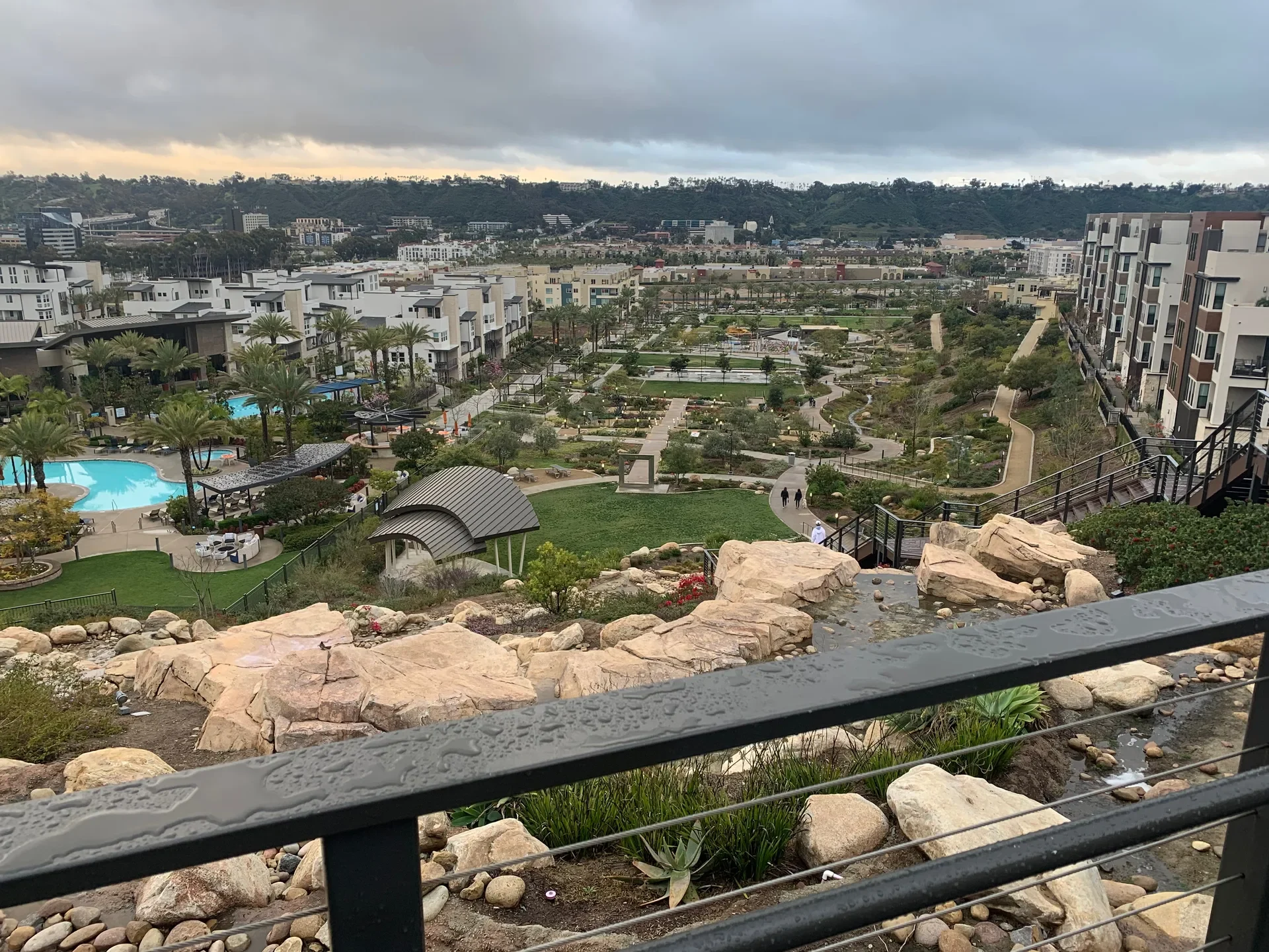 Terraced gardens and boulders in Civita Park with homes behind, Mission Valley, San Diego