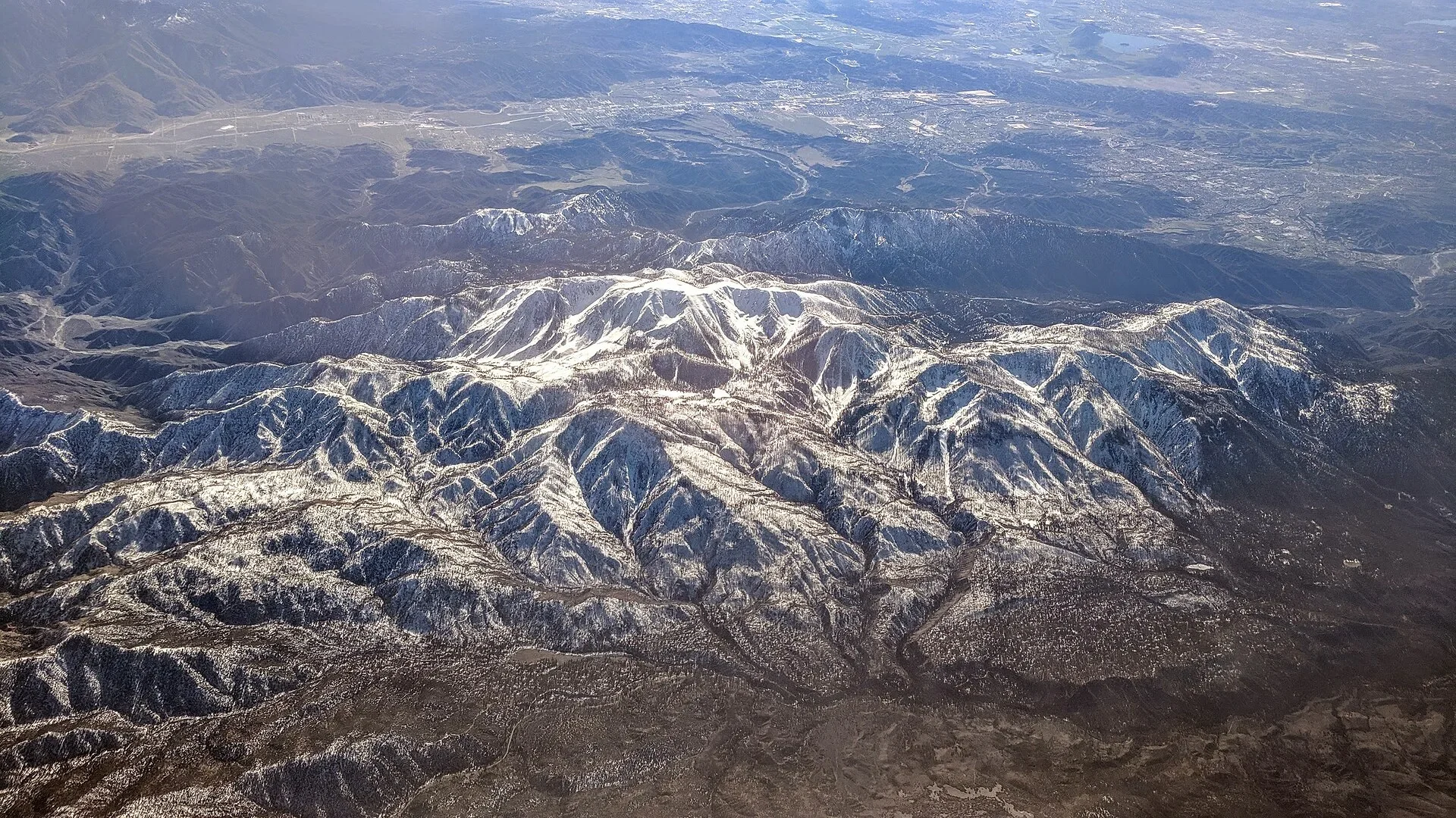 Aerial view of snow-streaked Mount San Gorgonio and the foothills above Banning, just east of Beaumont