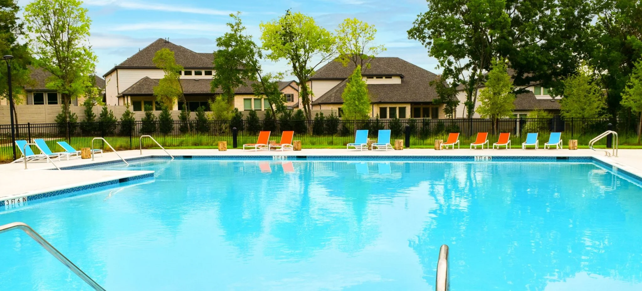 Lakeside Trailhead pool with new homes behind it in Painted Tree, McKinney, Texas