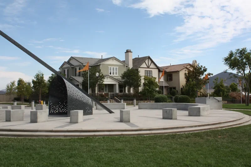 Plaza with a sculpture and homes behind it in the Del Sur community, San Diego