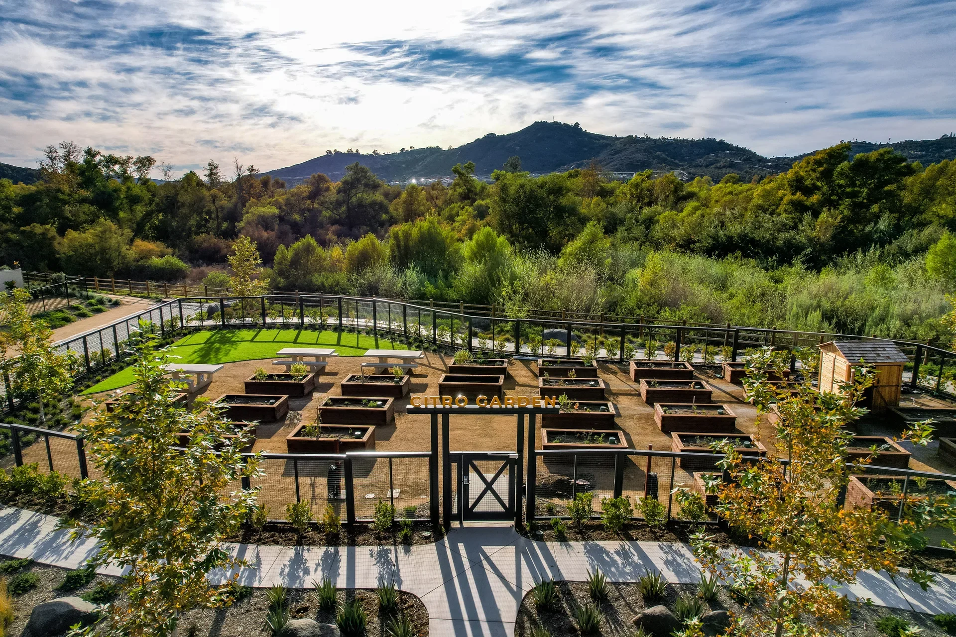 Raised garden beds at Citro Garden with hills beyond, in Citro, Fallbrook