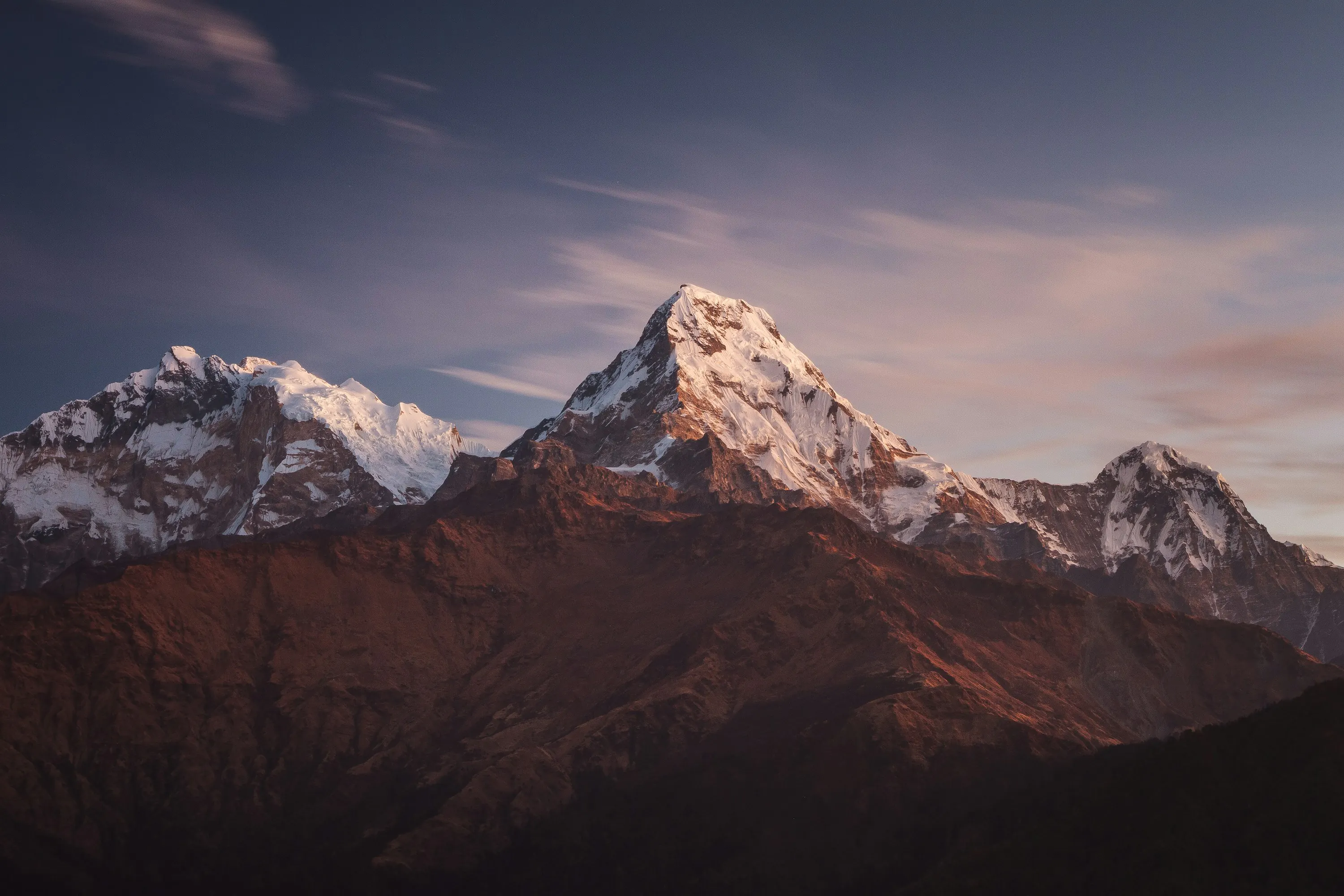 Three snow-covered mountain summits