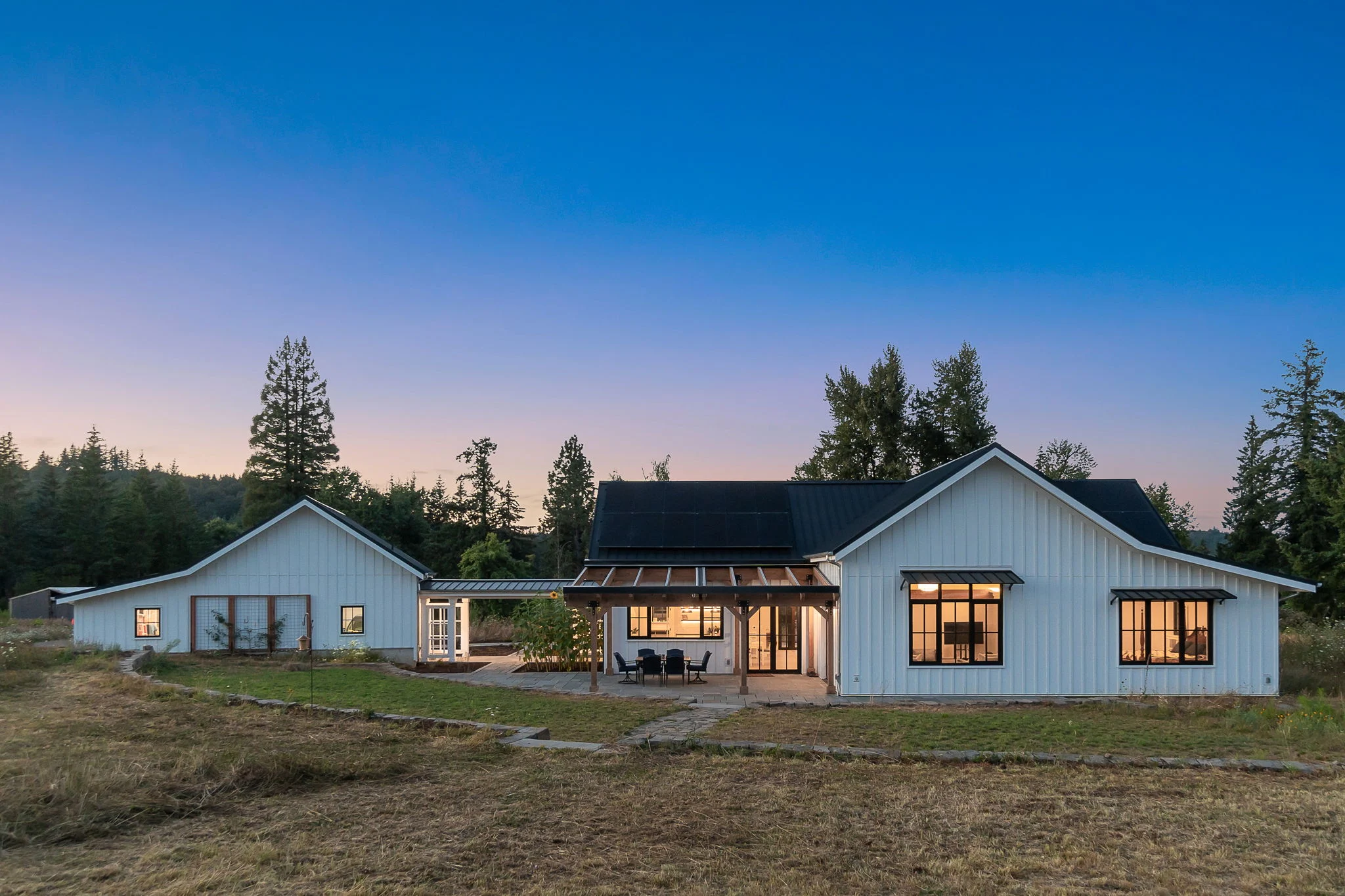 Damascus Passive House at dusk, a farmhouse-style Passive House built by Birdsmouth in Damascus, Oregon