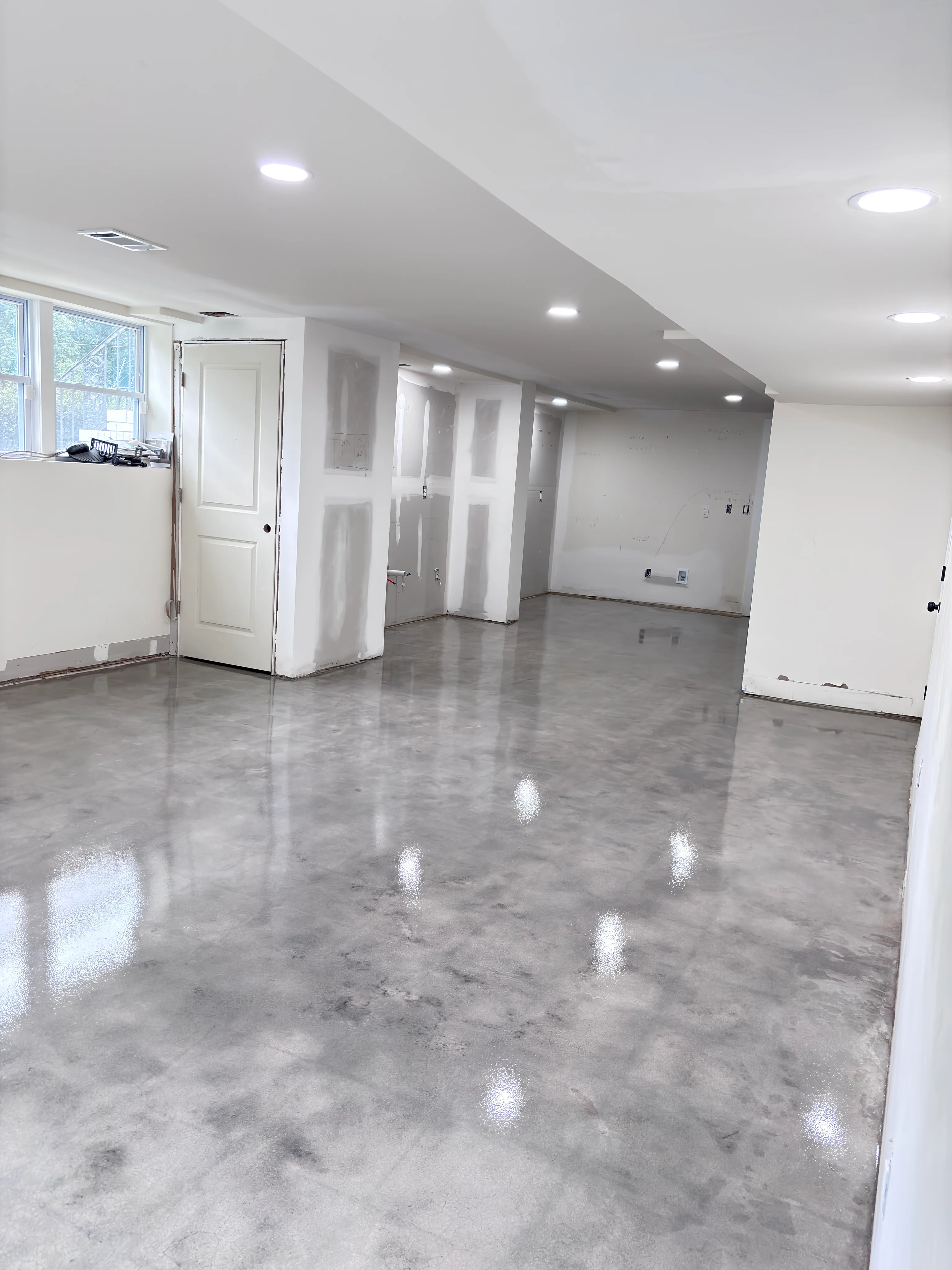 Glossy polished concrete floor in a basement interior