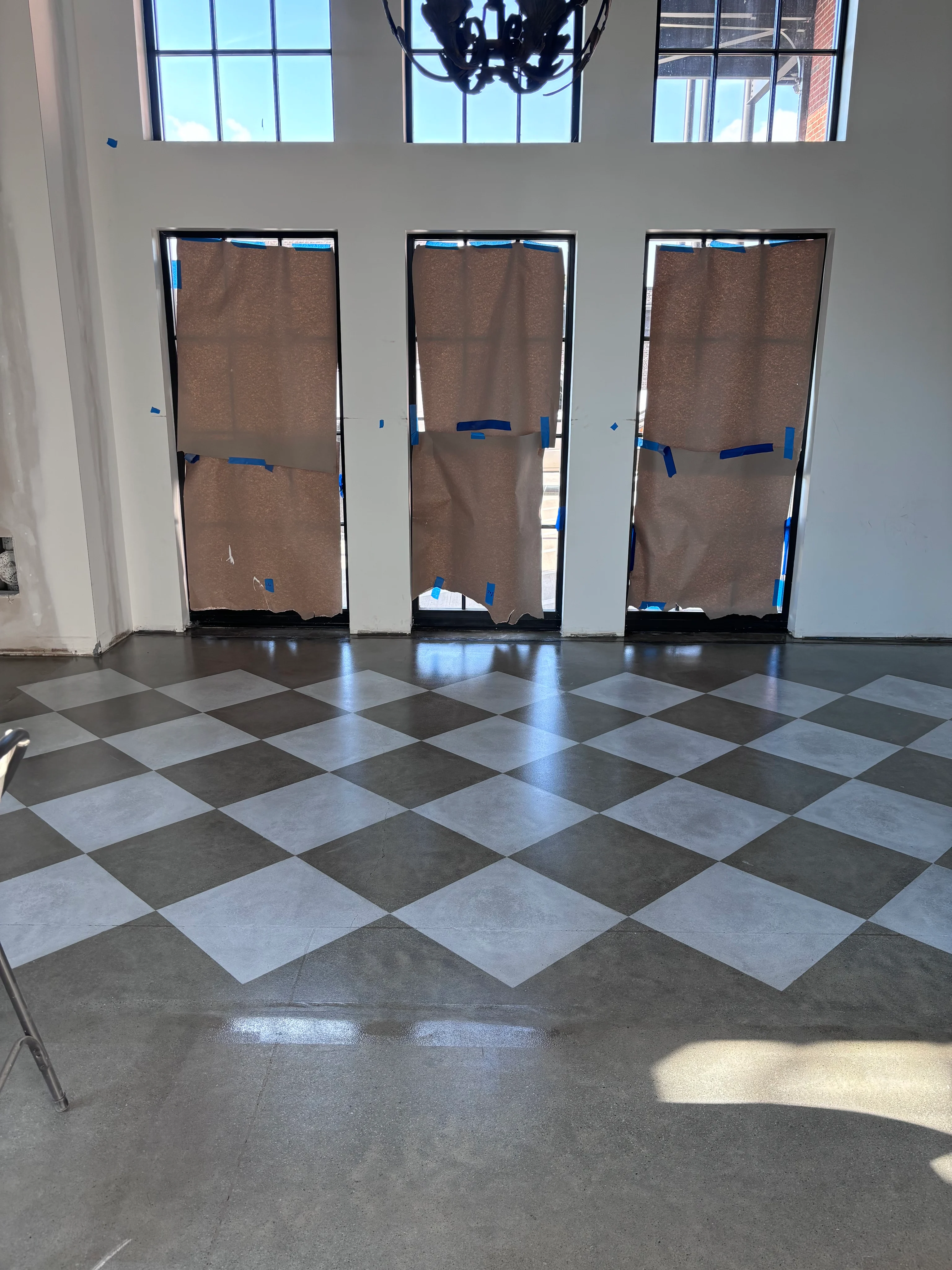 Gray and white checkered concrete floor in a room under construction