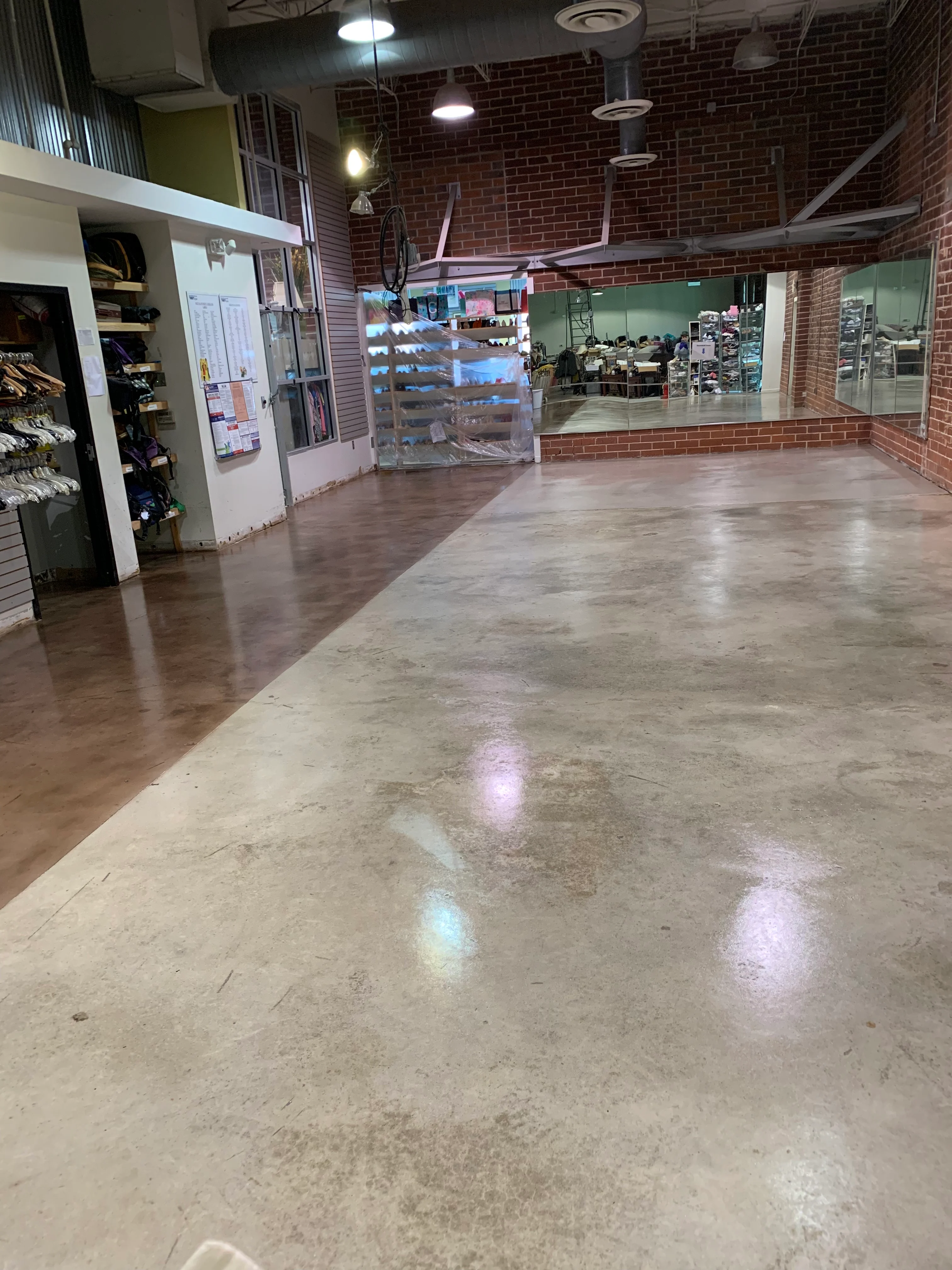Polished concrete floor in an industrial space with brick walls
