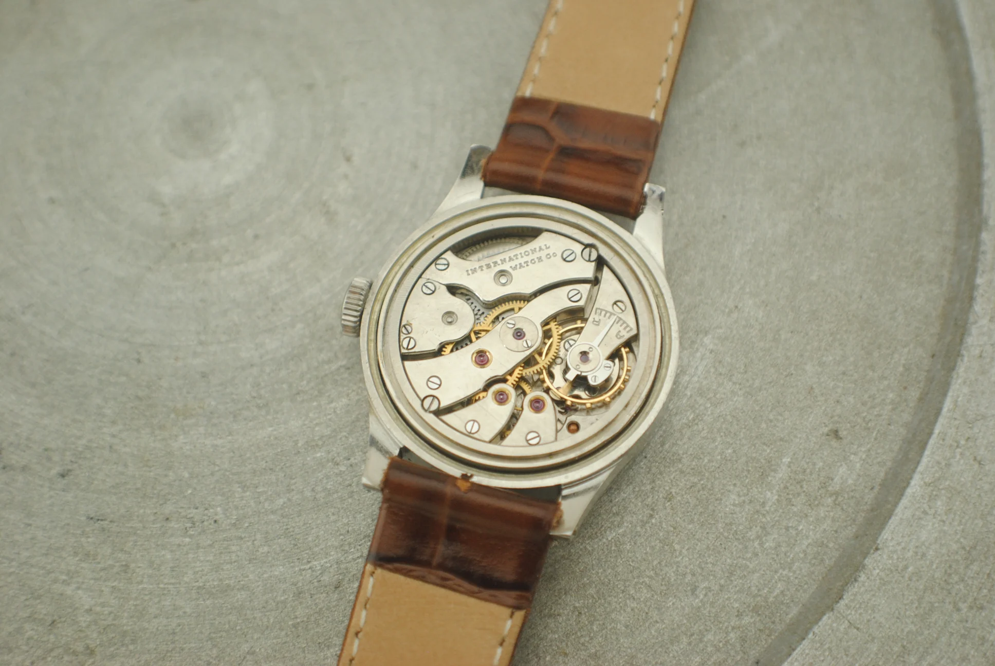 Open movement view of the IWC Calatrava Hermet with the International Watch Co signature and owner-identified calibre 83
