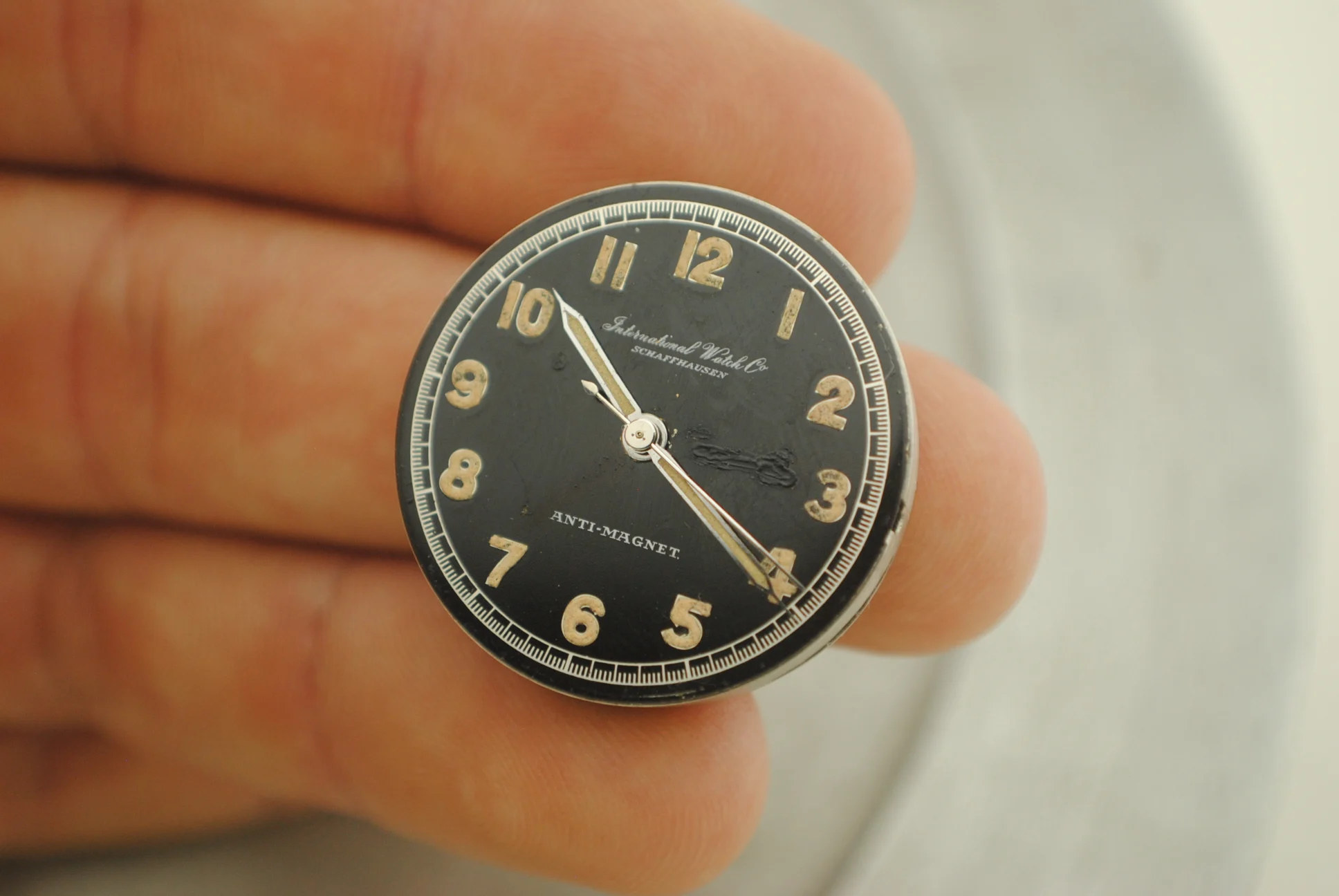 Alternate uncased IWC dial detail documenting the disclosed lacquer repair area and radium hands