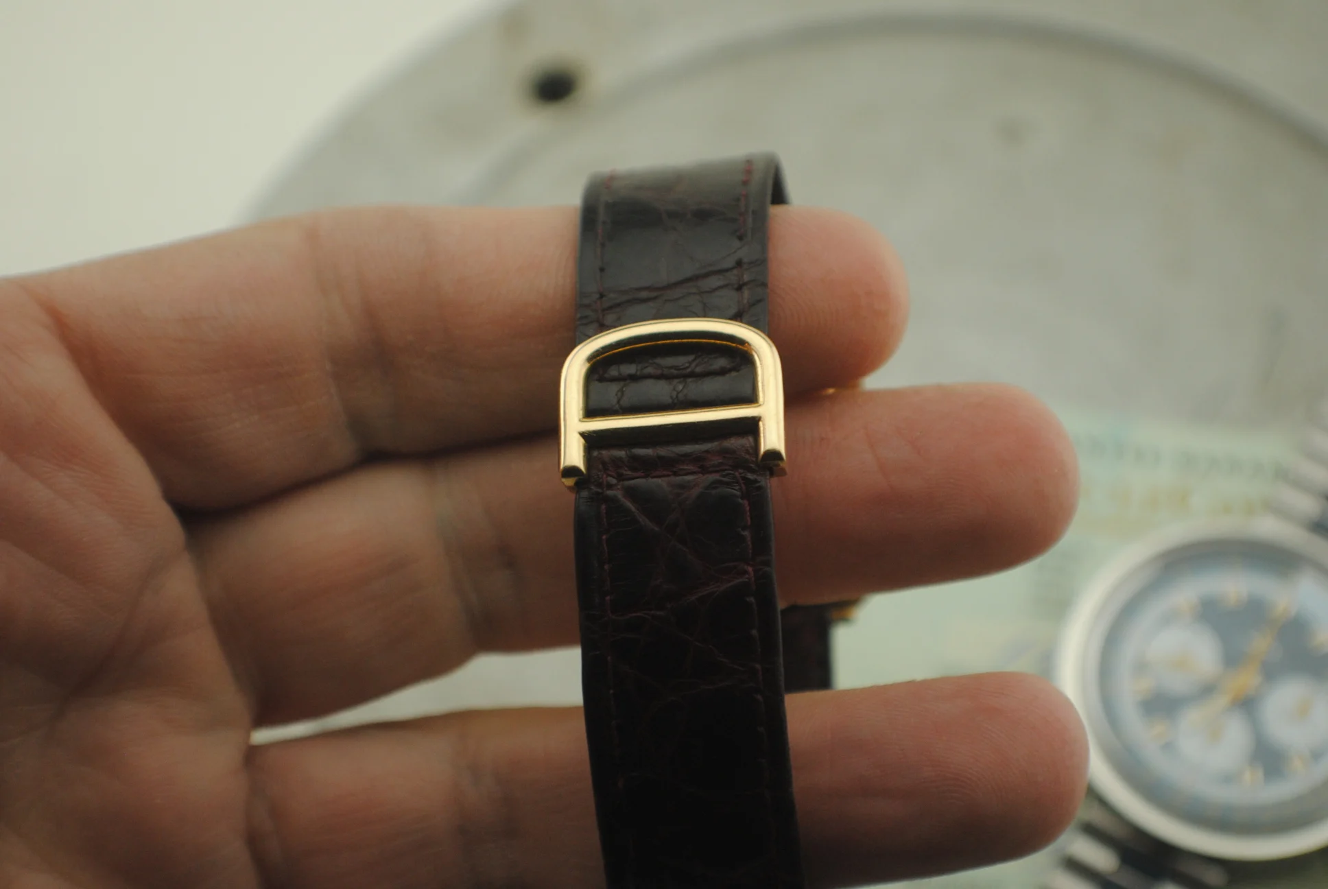 External view of the Cartier Cristallor folding clasp attached to the dark leather strap