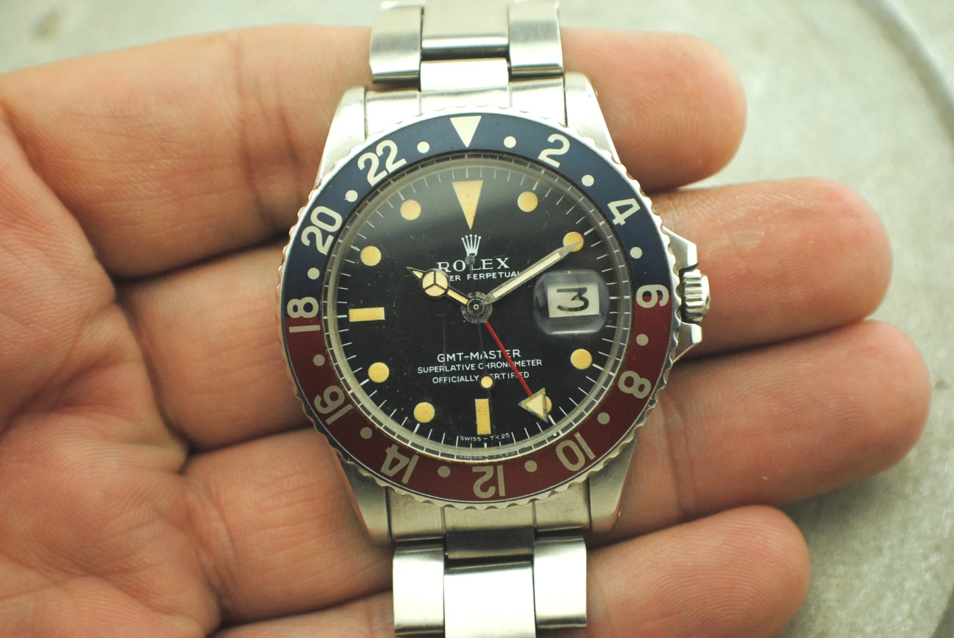 Alternate in-hand crystal-on view of the Rolex GMT-Master 1675, with the date magnifier, red GMT hand and red-and-blue bezel visible
