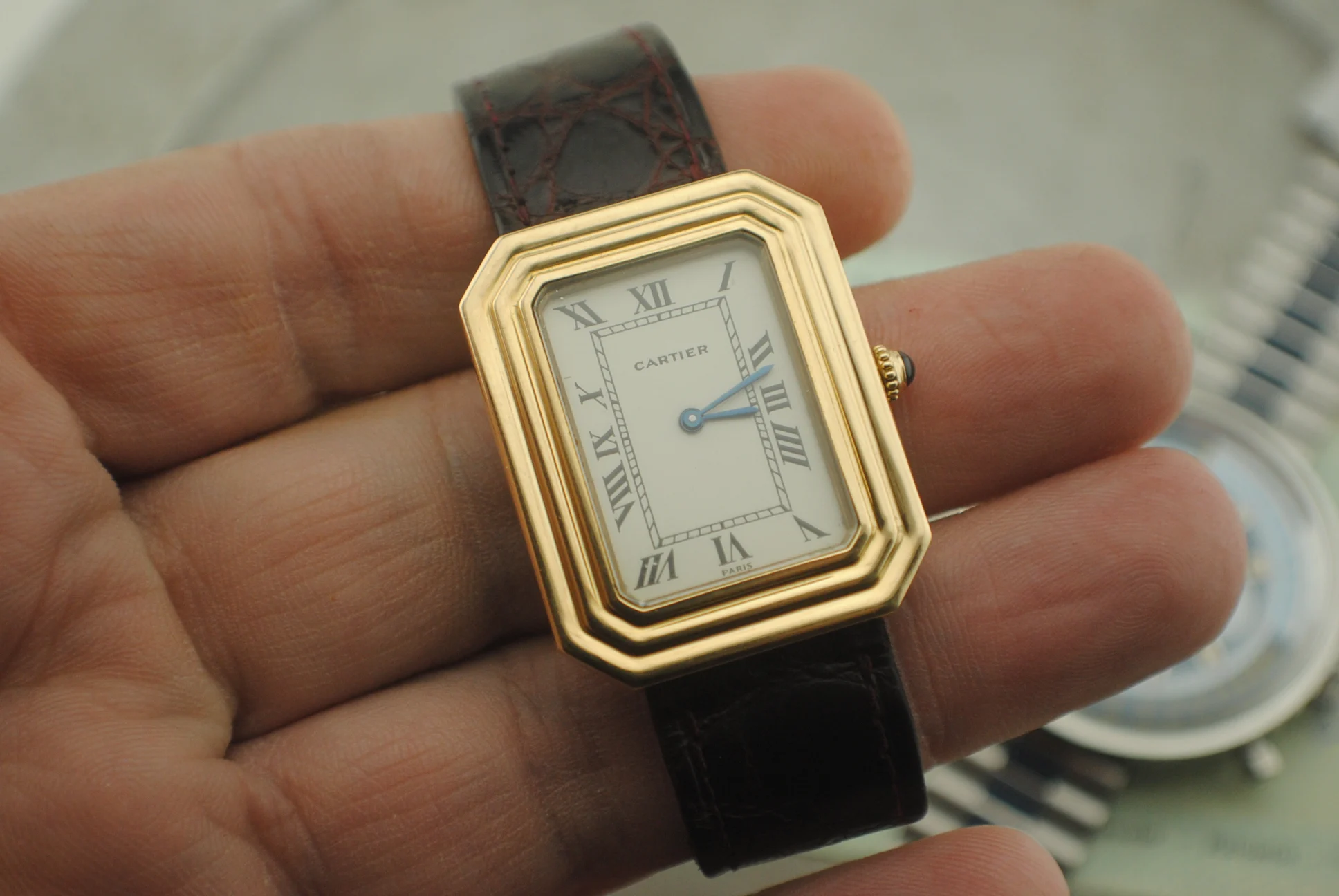 Alternate crystal-on front view of the Cartier Cristallor with Cartier and Paris dial signatures, cabochon crown and dark strap