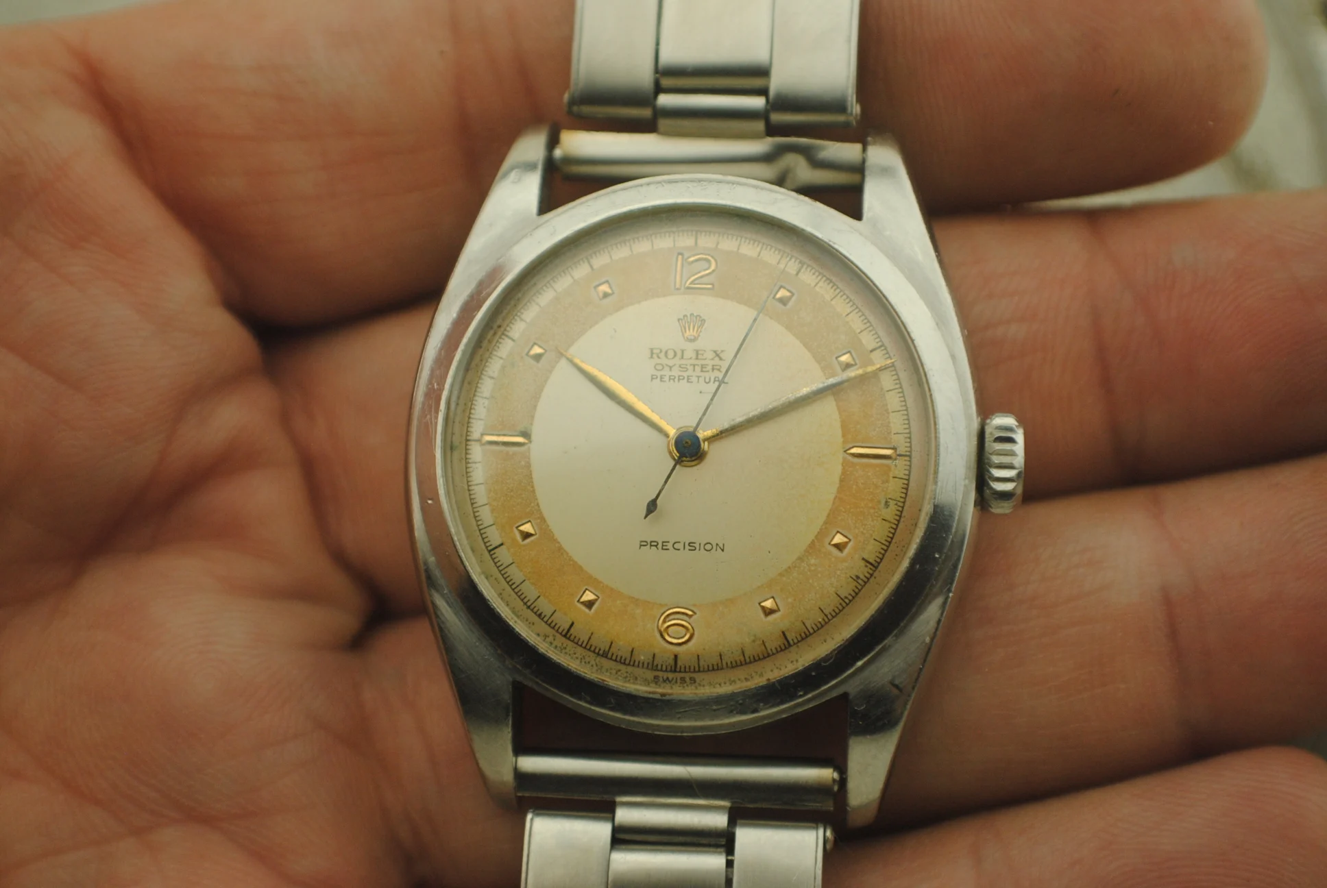 Alternate crystal-on close-up of the Rolex 6098 dial, crown and straight bracelet end links