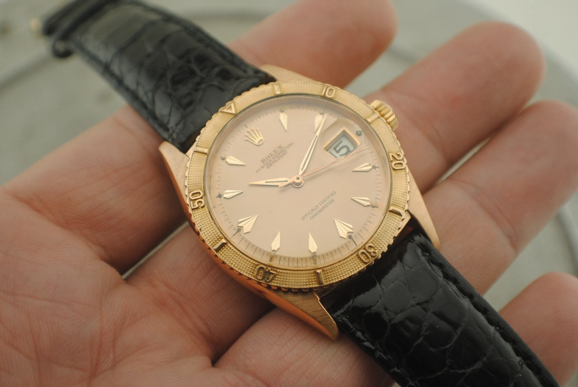 Closer view of the Rolex Thunderbird 6309 showing its pink dial, hands, date window and bezel