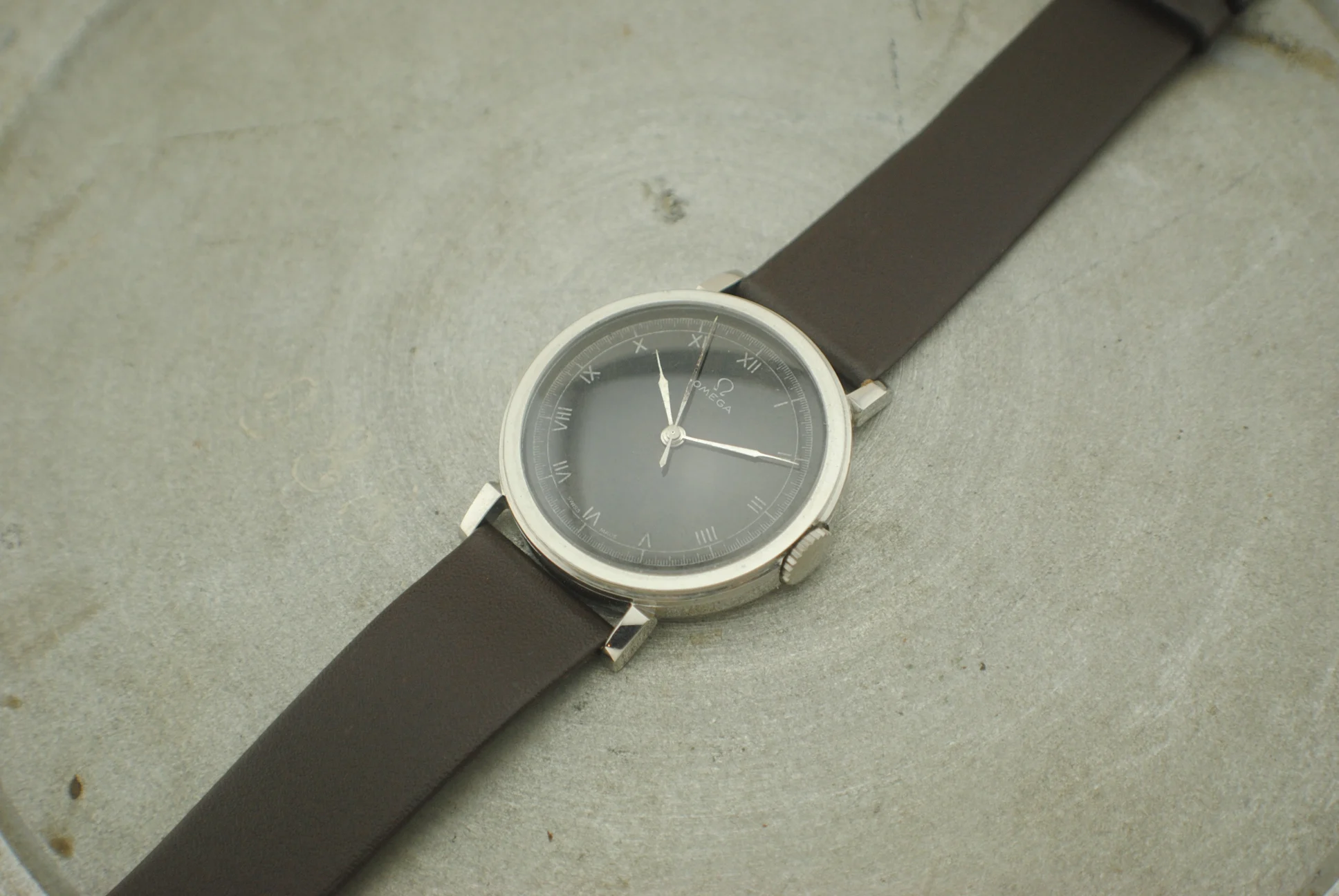 Wider crystal-on view of the Omega CK2015 Fagiolino with its brown leather strap