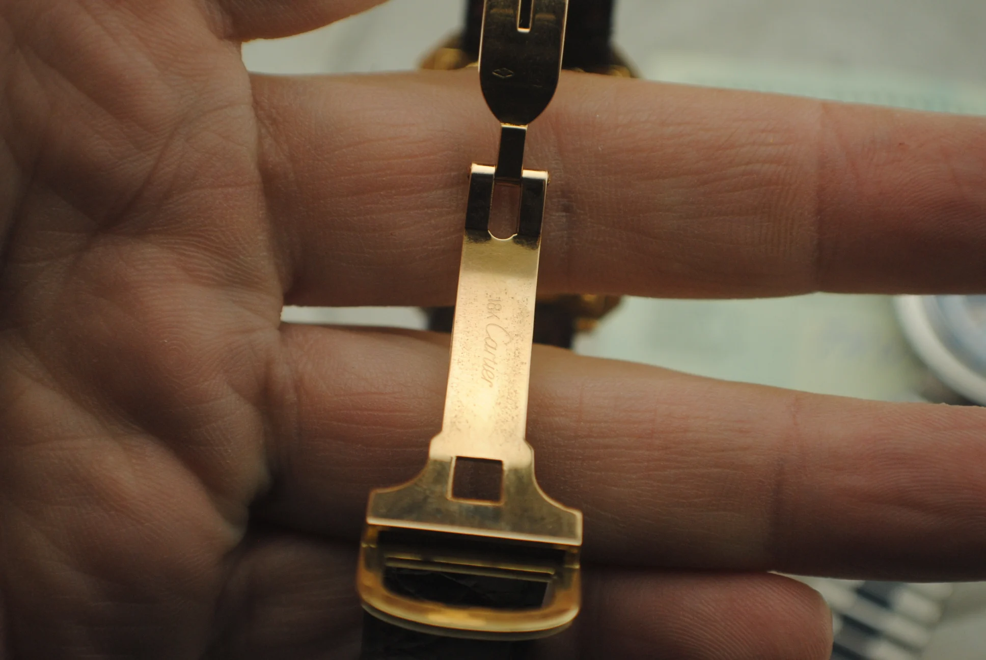 Interior of the Cartier Cristallor folding clasp showing the Cartier signature and 18K marking