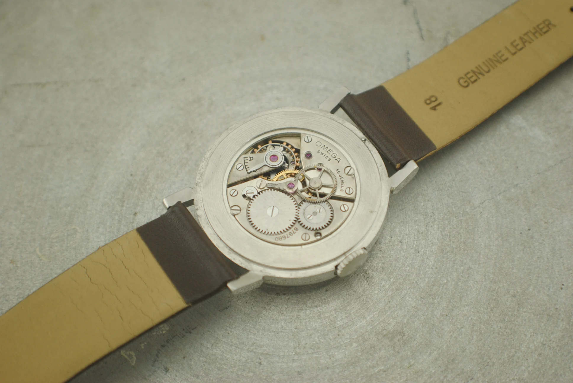 Open Omega CK2015 Fagiolino case showing the signed Omega 23.4 movement