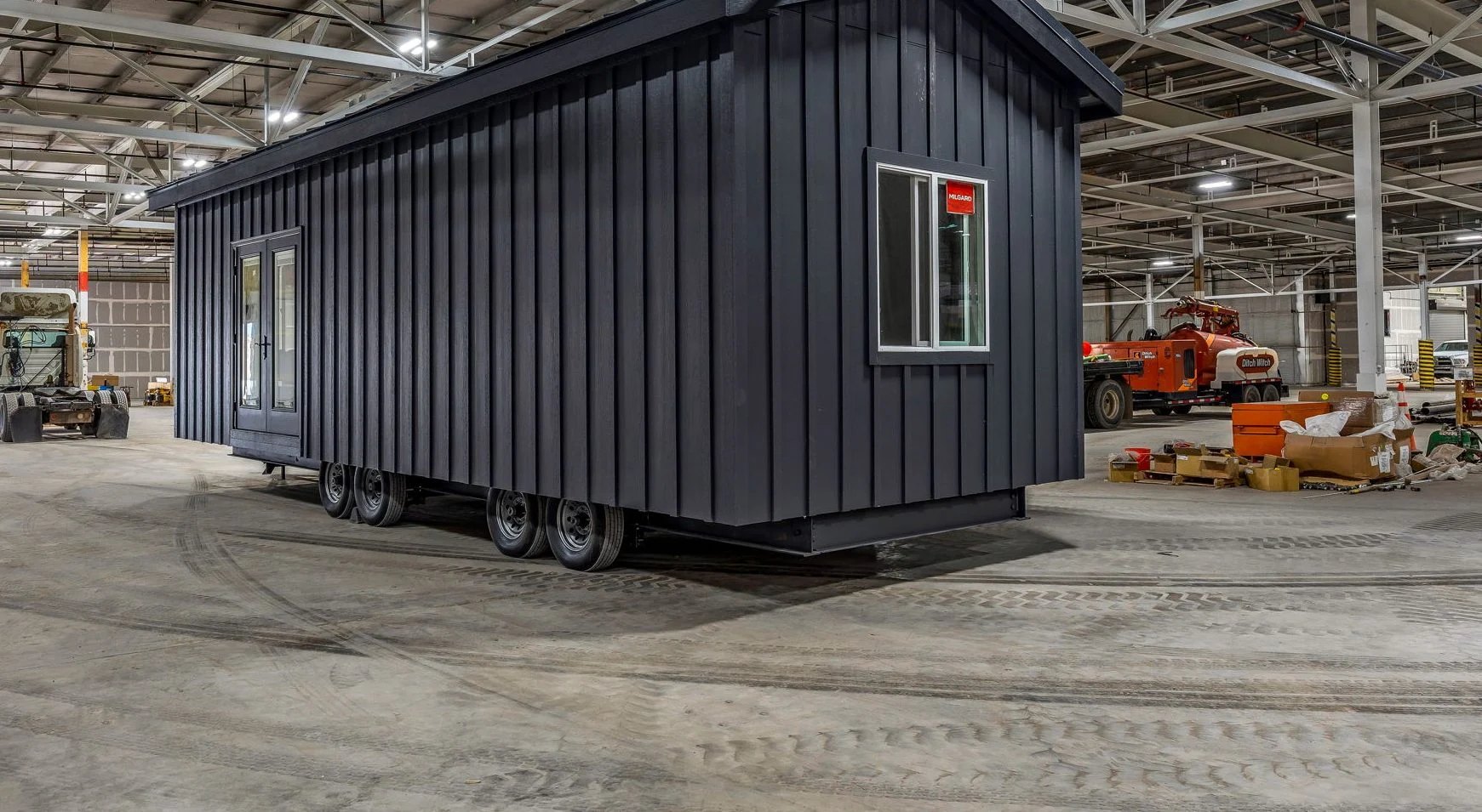 Dark gray Basecamp cabin on its chassis inside the Mytikas factory.