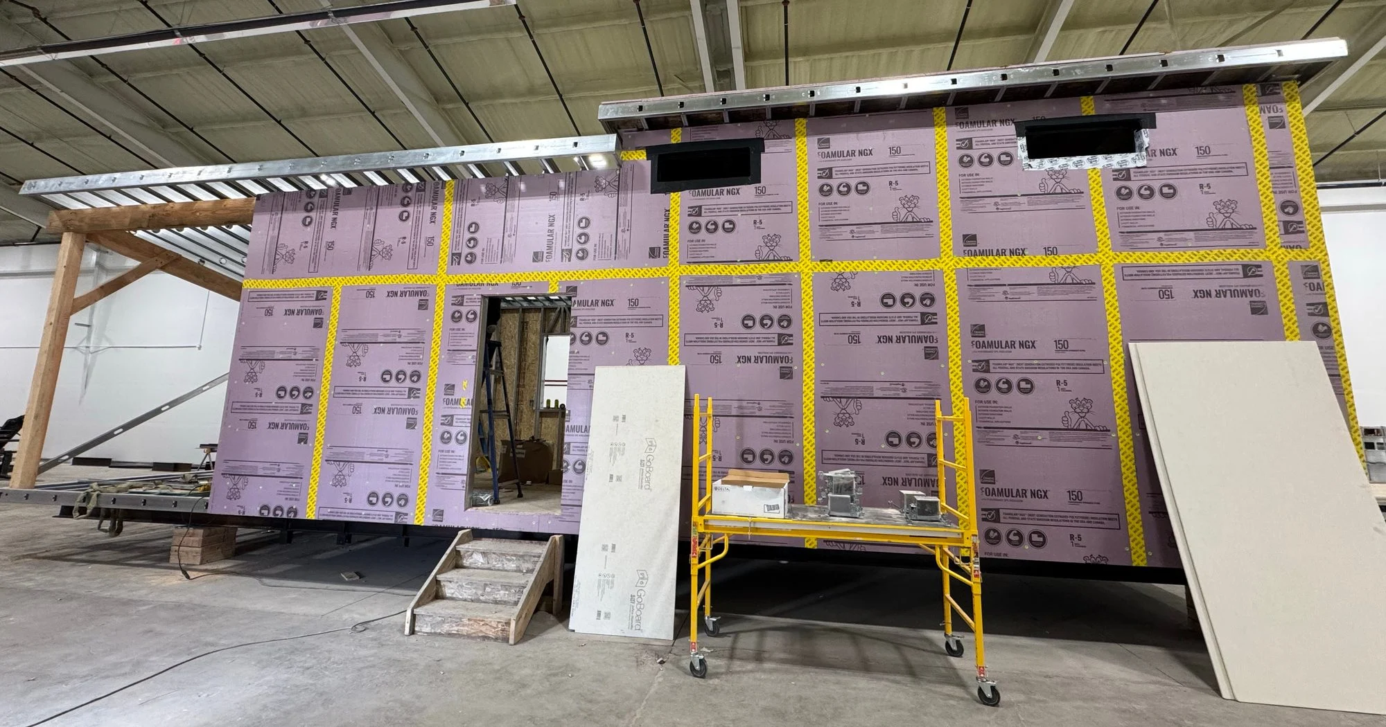 Ridgeline cabin with taped rigid insulation during construction