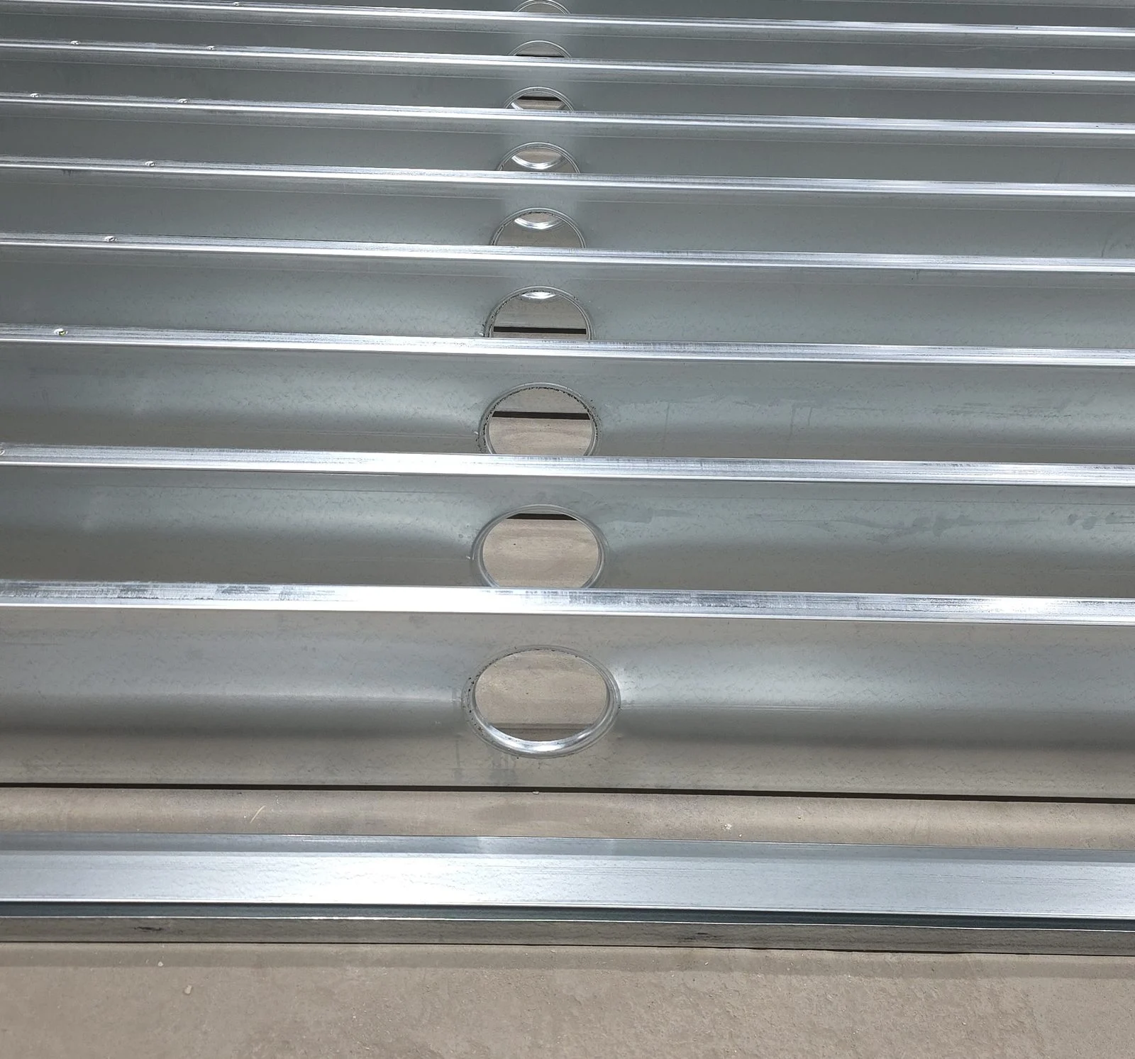 Parallel steel joists with punched service openings