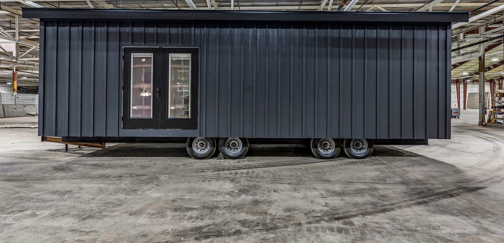 Side of a dark Basecamp cabin on the factory floor