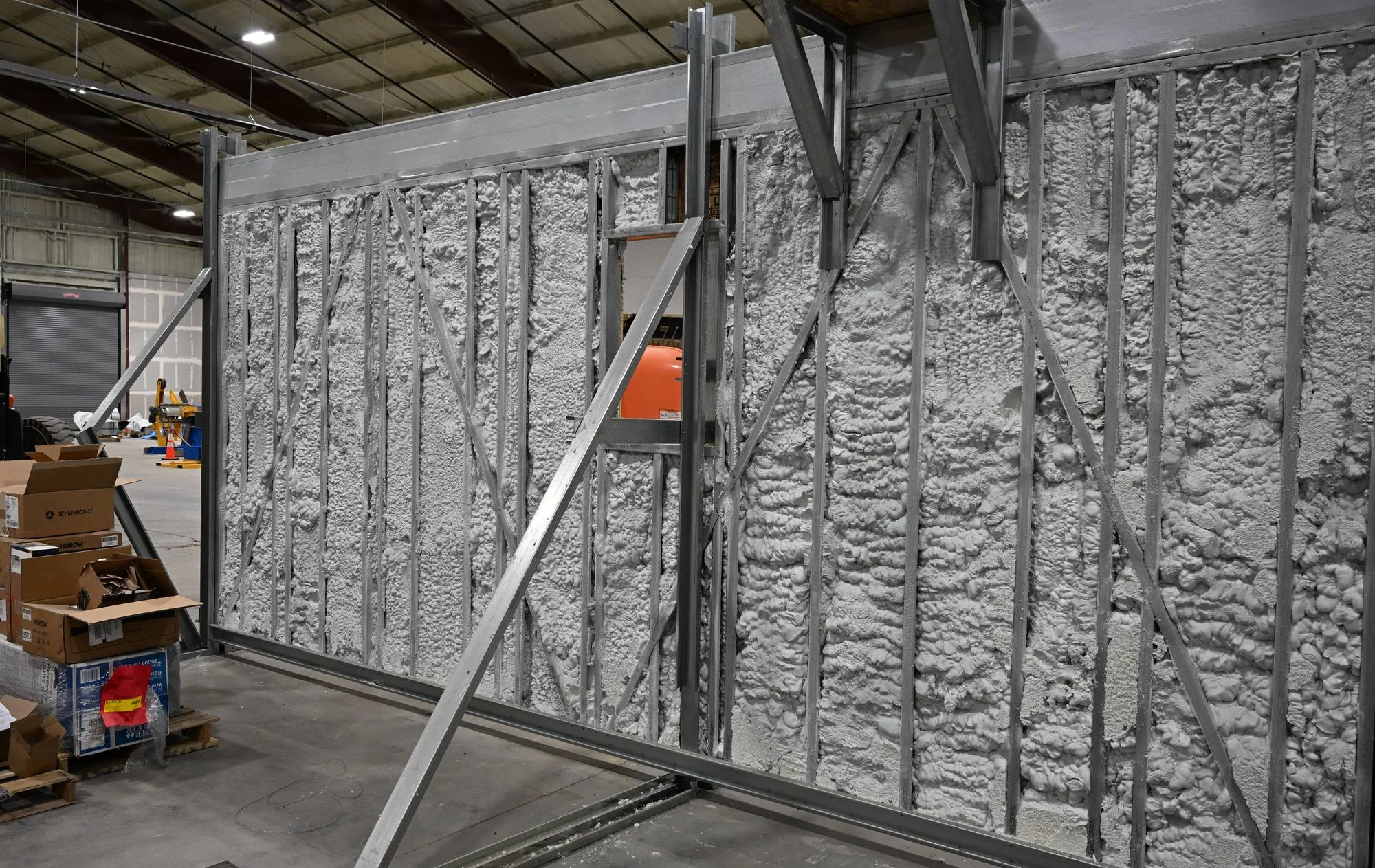 Closed-cell foam filling the cavities of a steel-framed wall