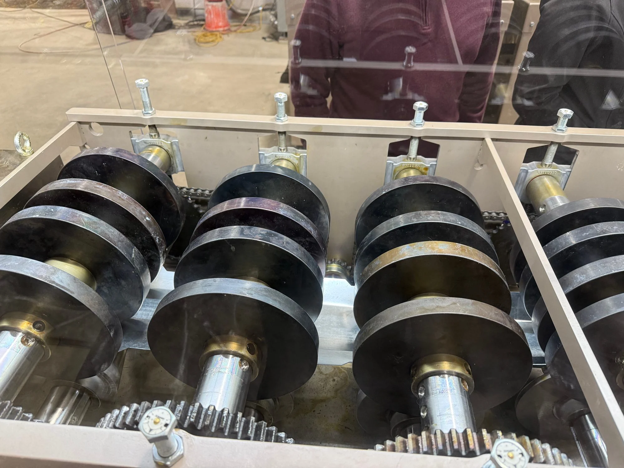 Rollers and gears inside a steel roll-forming machine