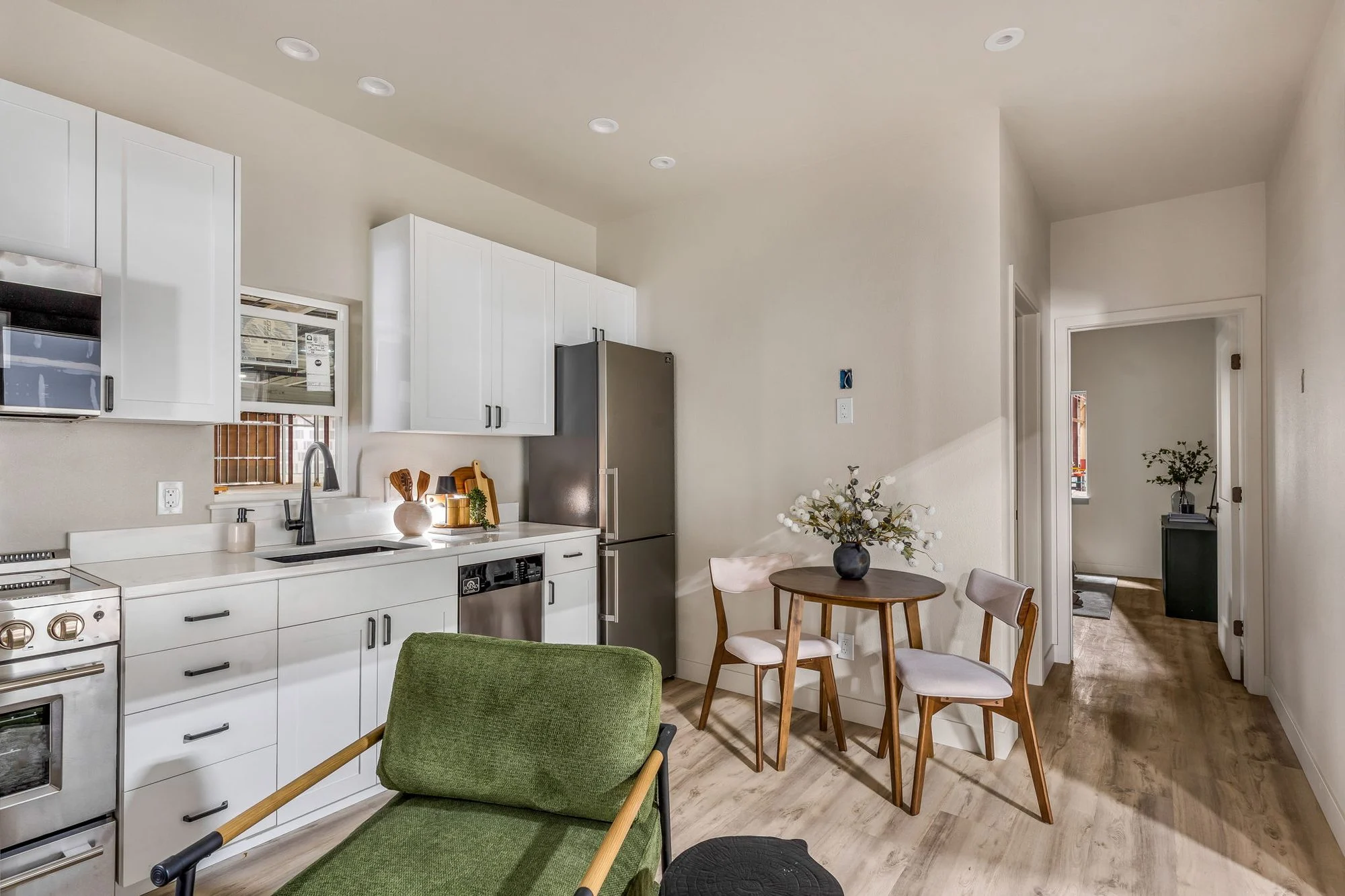 Basecamp kitchen with white cabinetry and a small dining table
