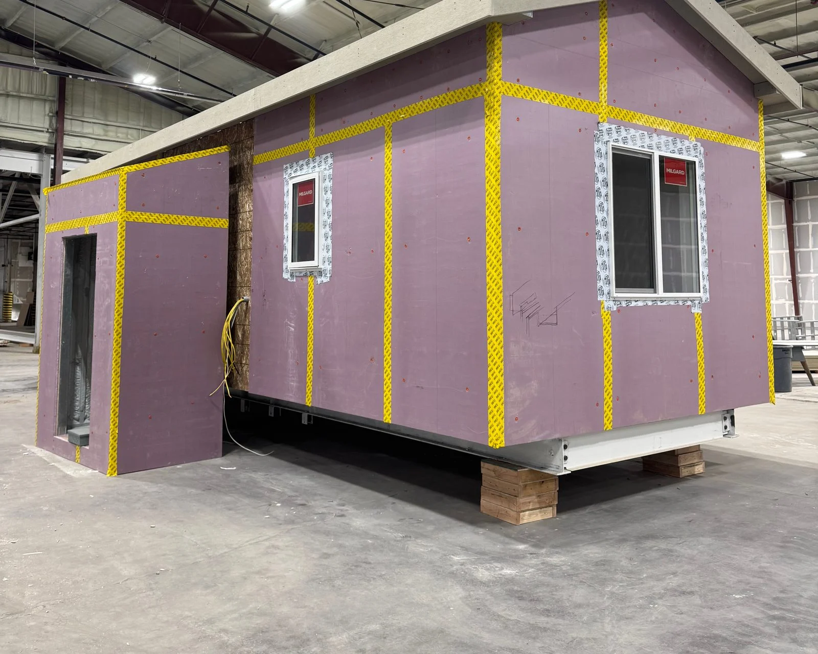 Basecamp cabin wrapped in rigid insulation with taped seams