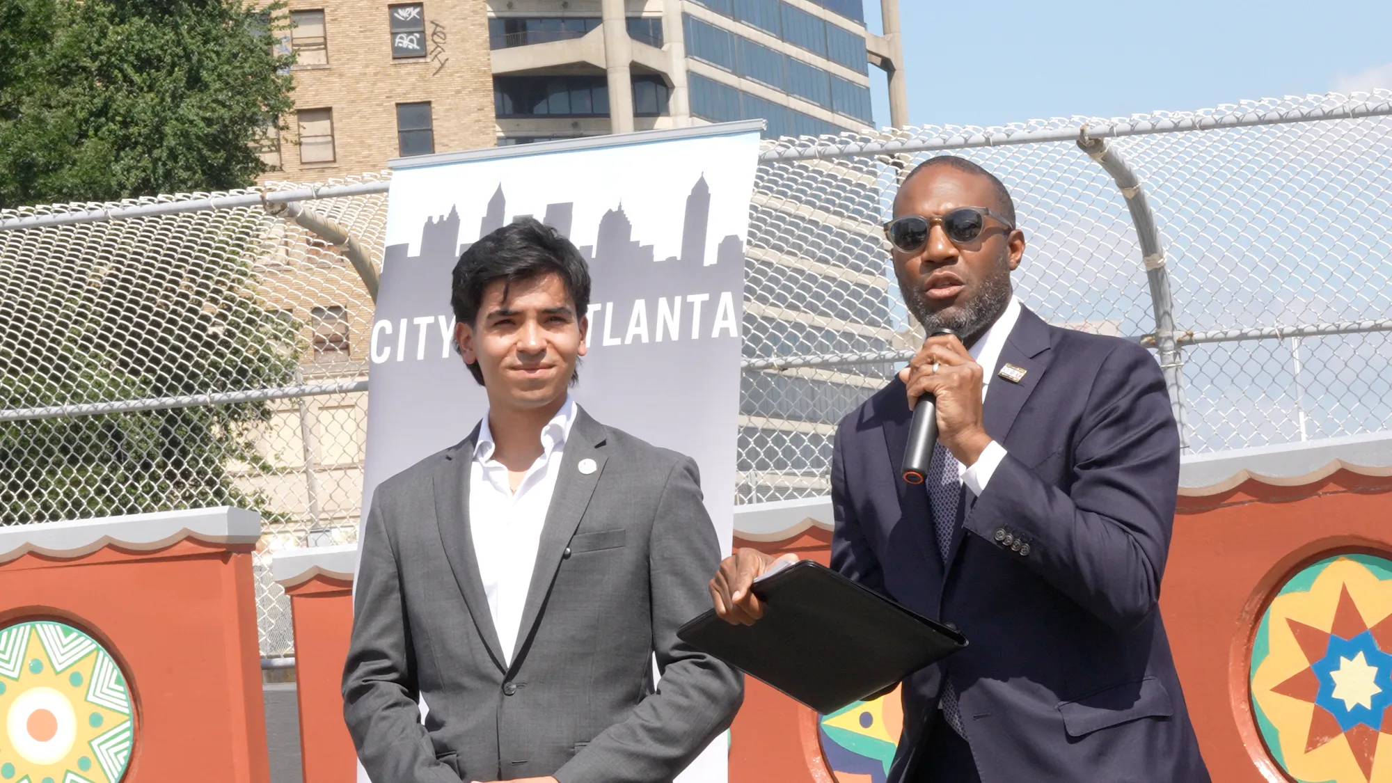 Atlanta Transportation Commissioner Solomon Caviness speaking beside CYVL CEO Daniel Pelaez