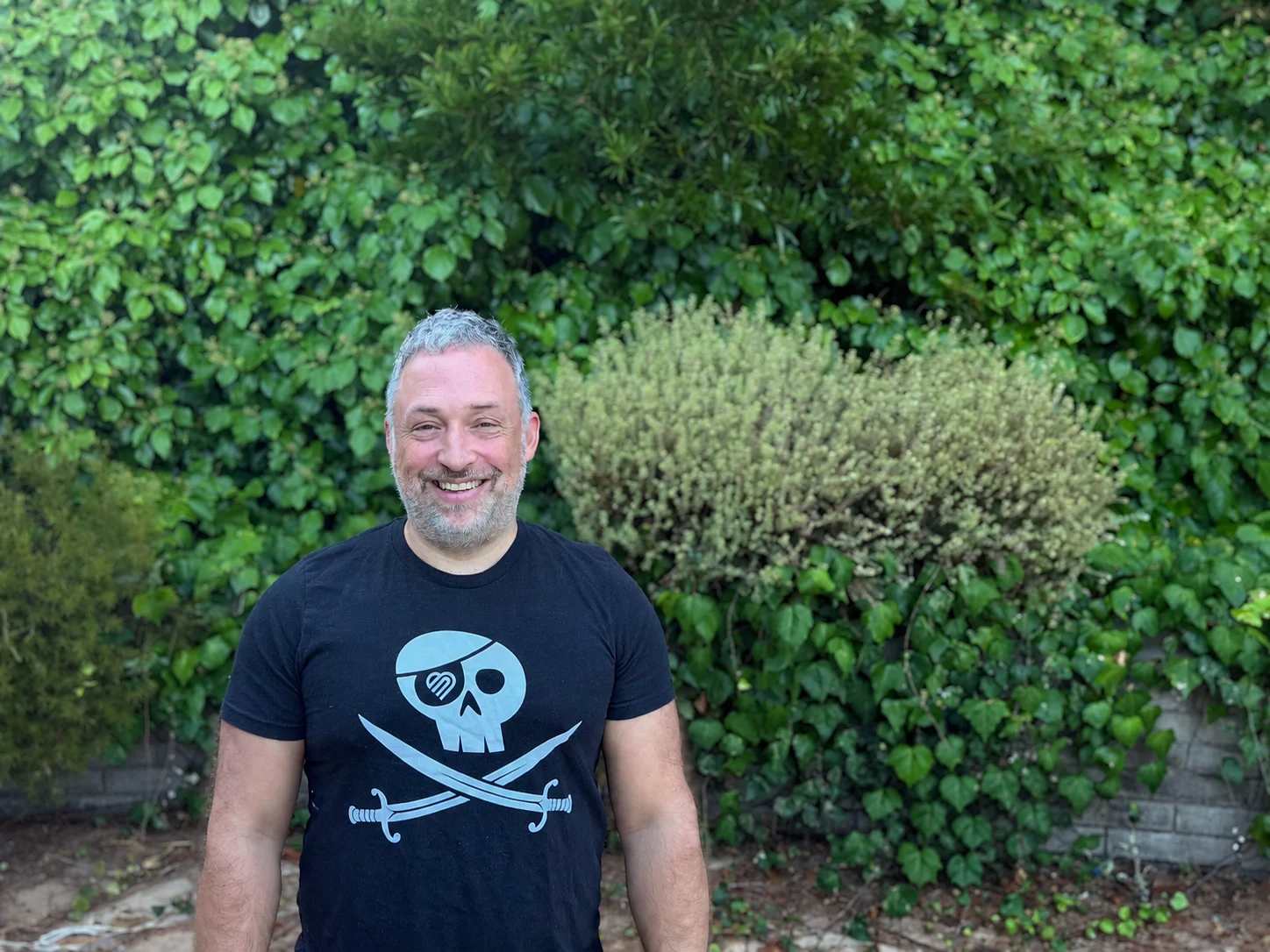 Nick Soman wearing a Decent pirate shirt outdoors.