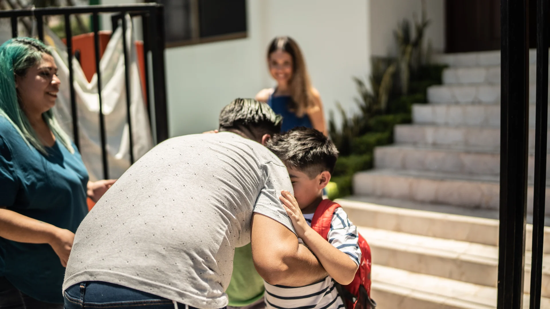 Family saying goodbye at the start of a school day