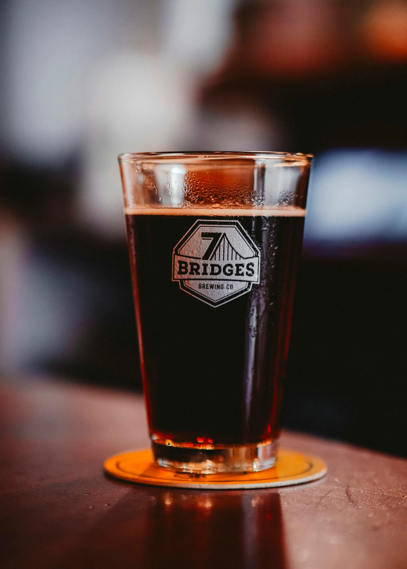 Illustrative photograph: a dark reddish beer in a 7 Bridges Brewing glass, not a claimed brown ale