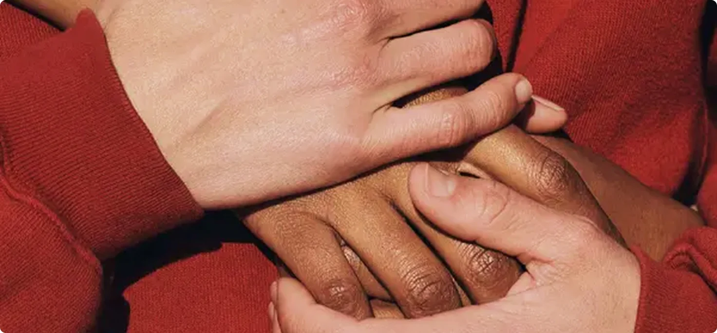 Several people placing their hands together.