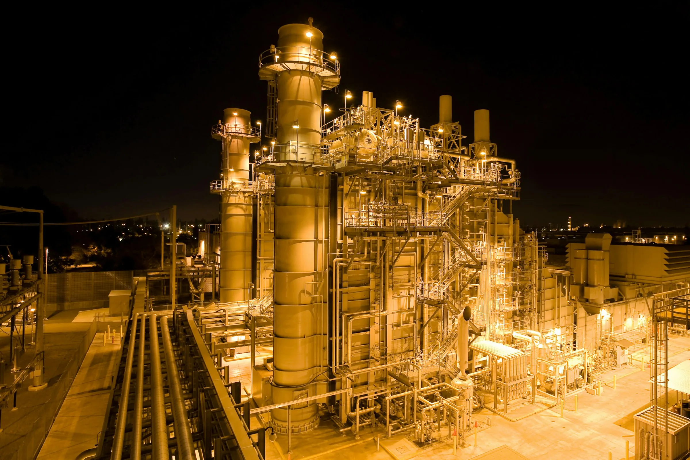 A gas-fired power plant illuminated at night