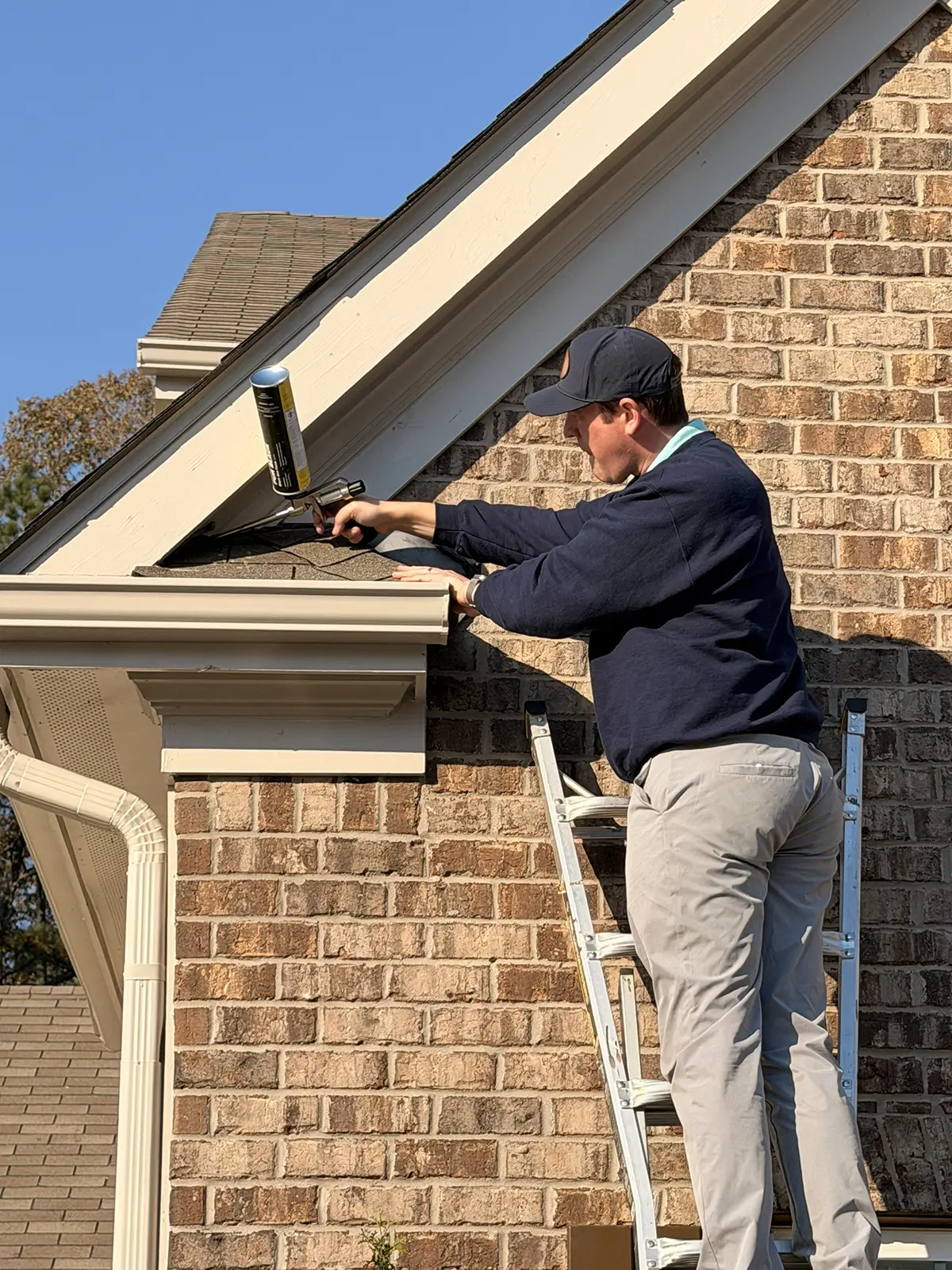 Safe Haven technician working on a home's eaves