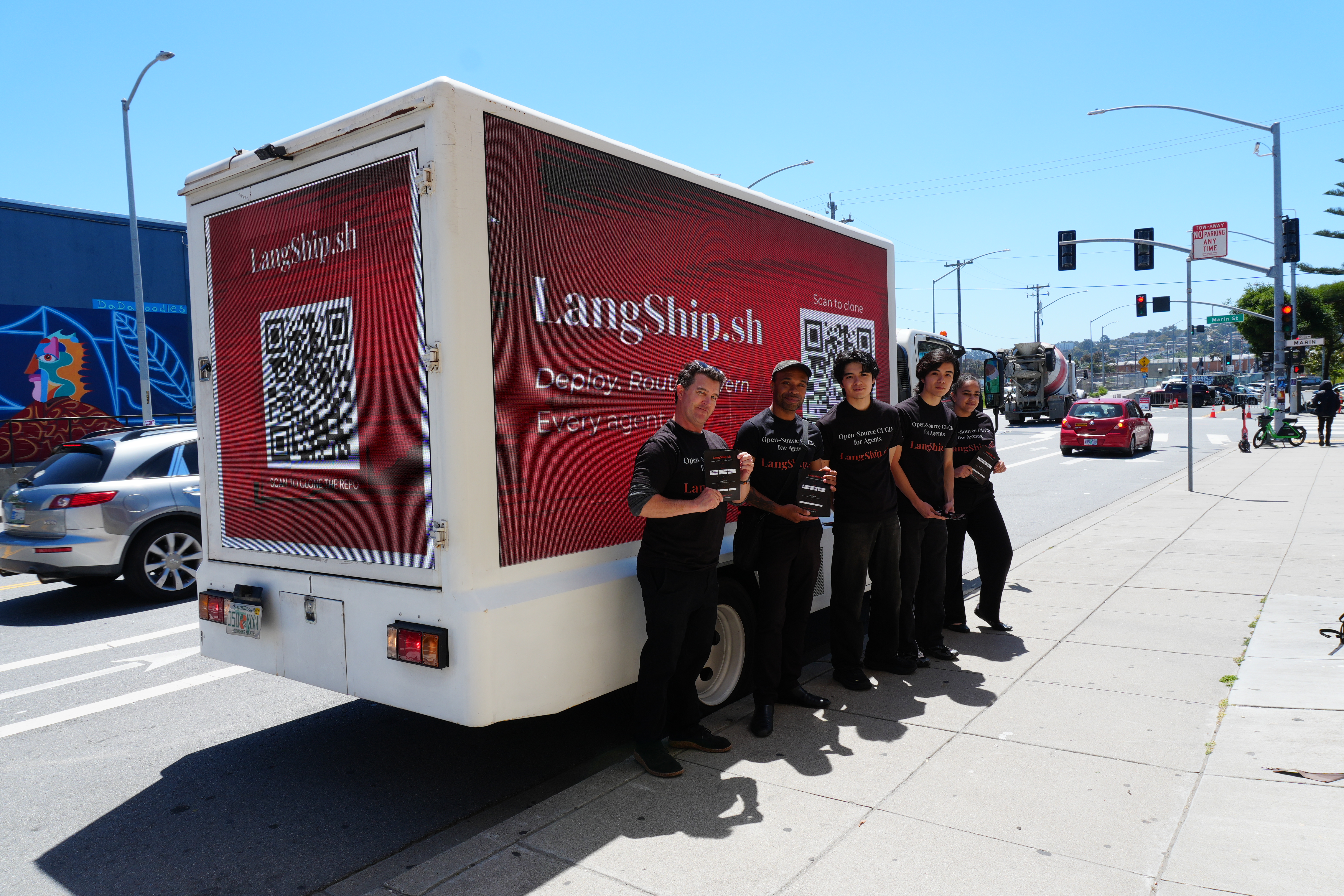 LangShip.sh branded LED truck with a street team on a city street