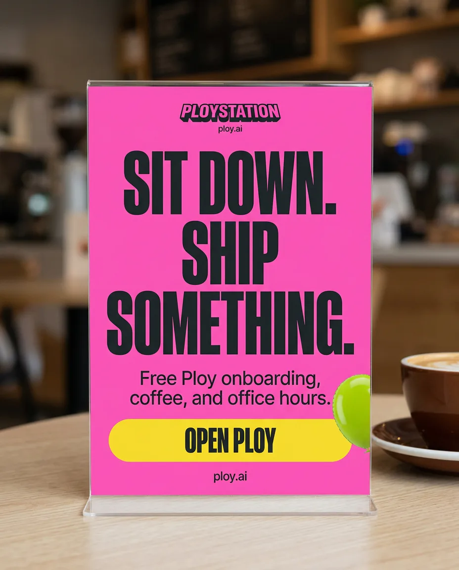 Pink Ploystation café table sign reading Sit down. Ship something.
