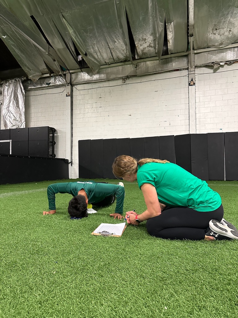 A HeyCoach coach recording an athlete's push-up test results